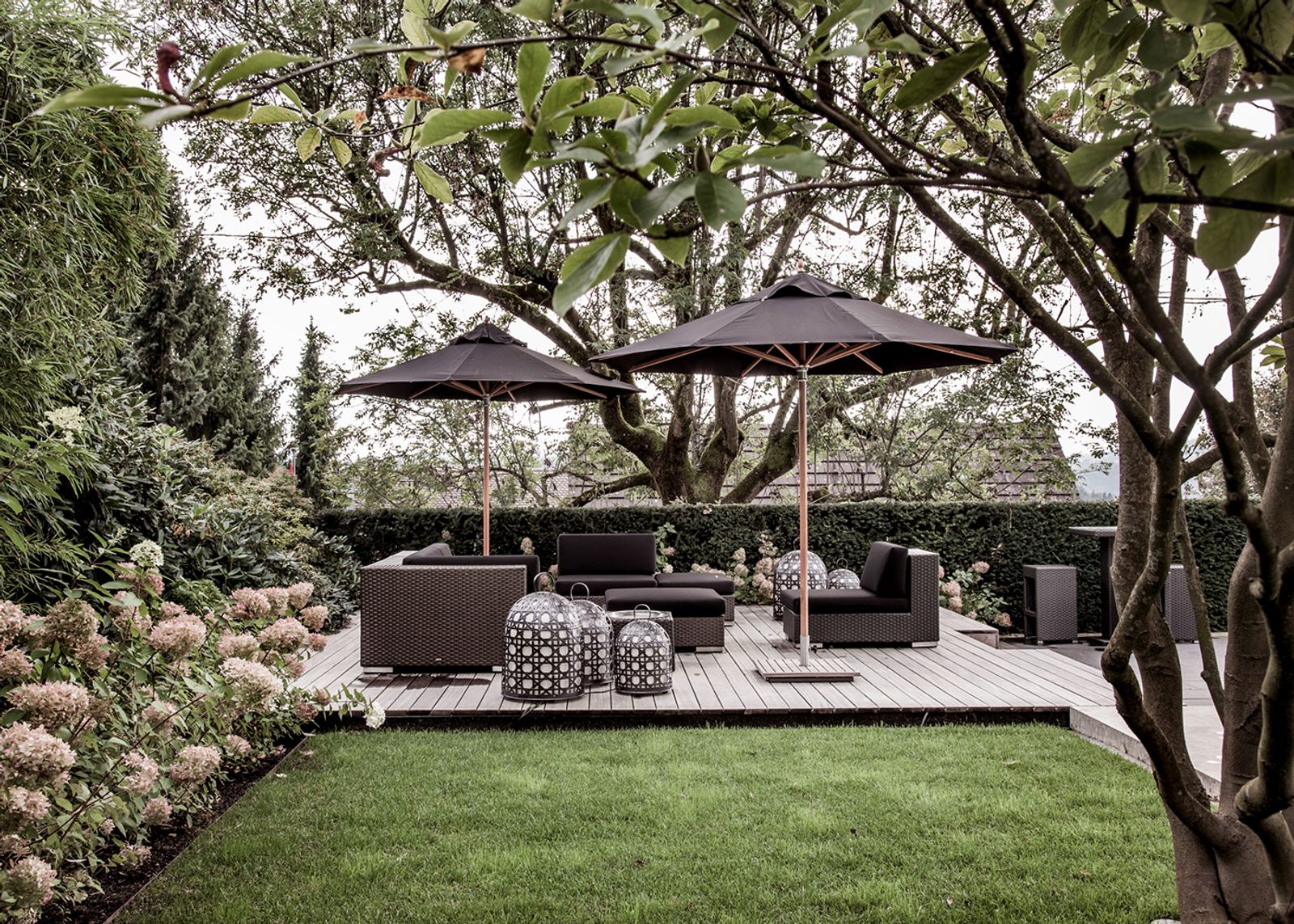 Lounge with parasols beneath mature trees