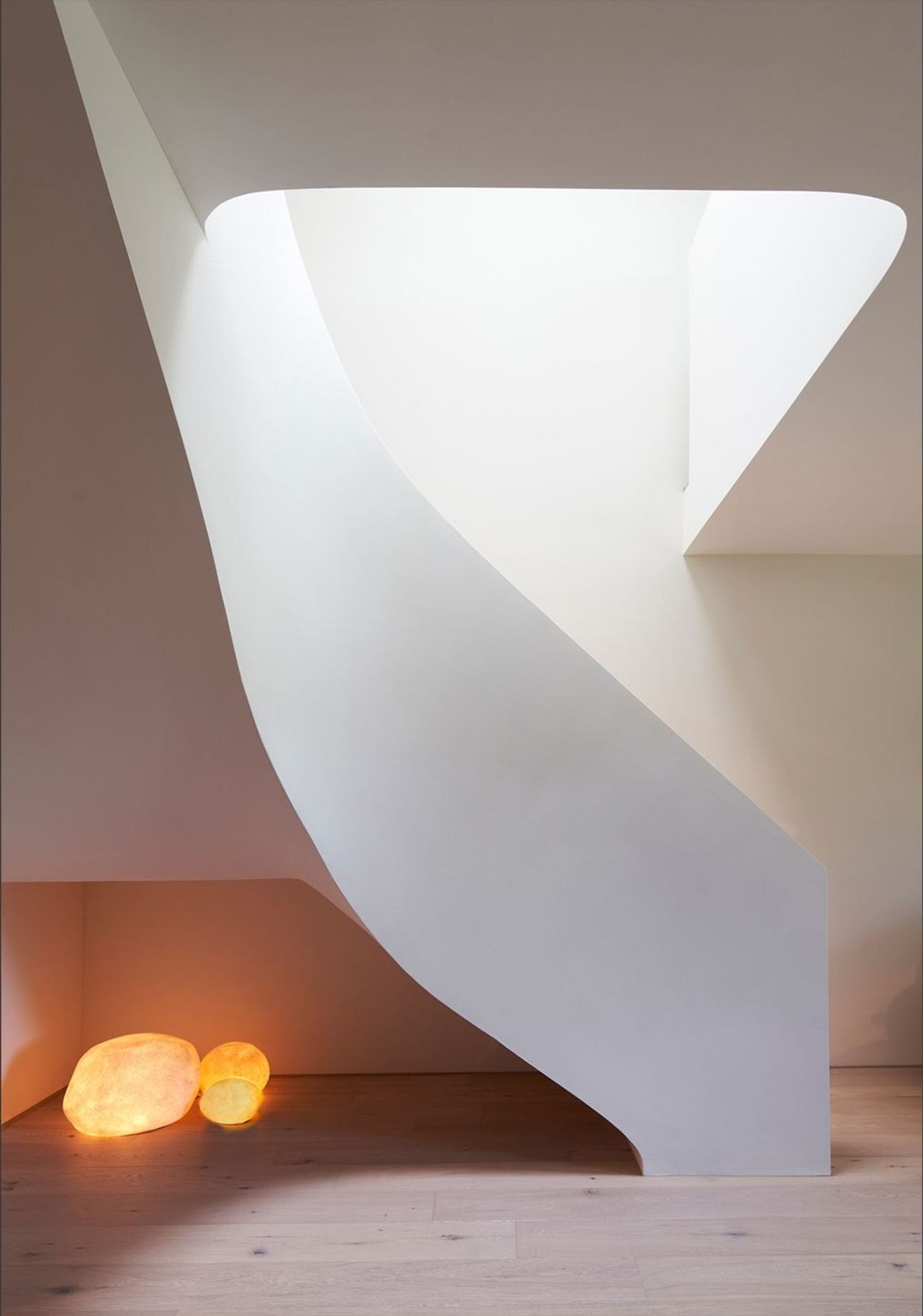 Underside of the curved staircase with glowing stones – Interiors and landscape, Wettswil