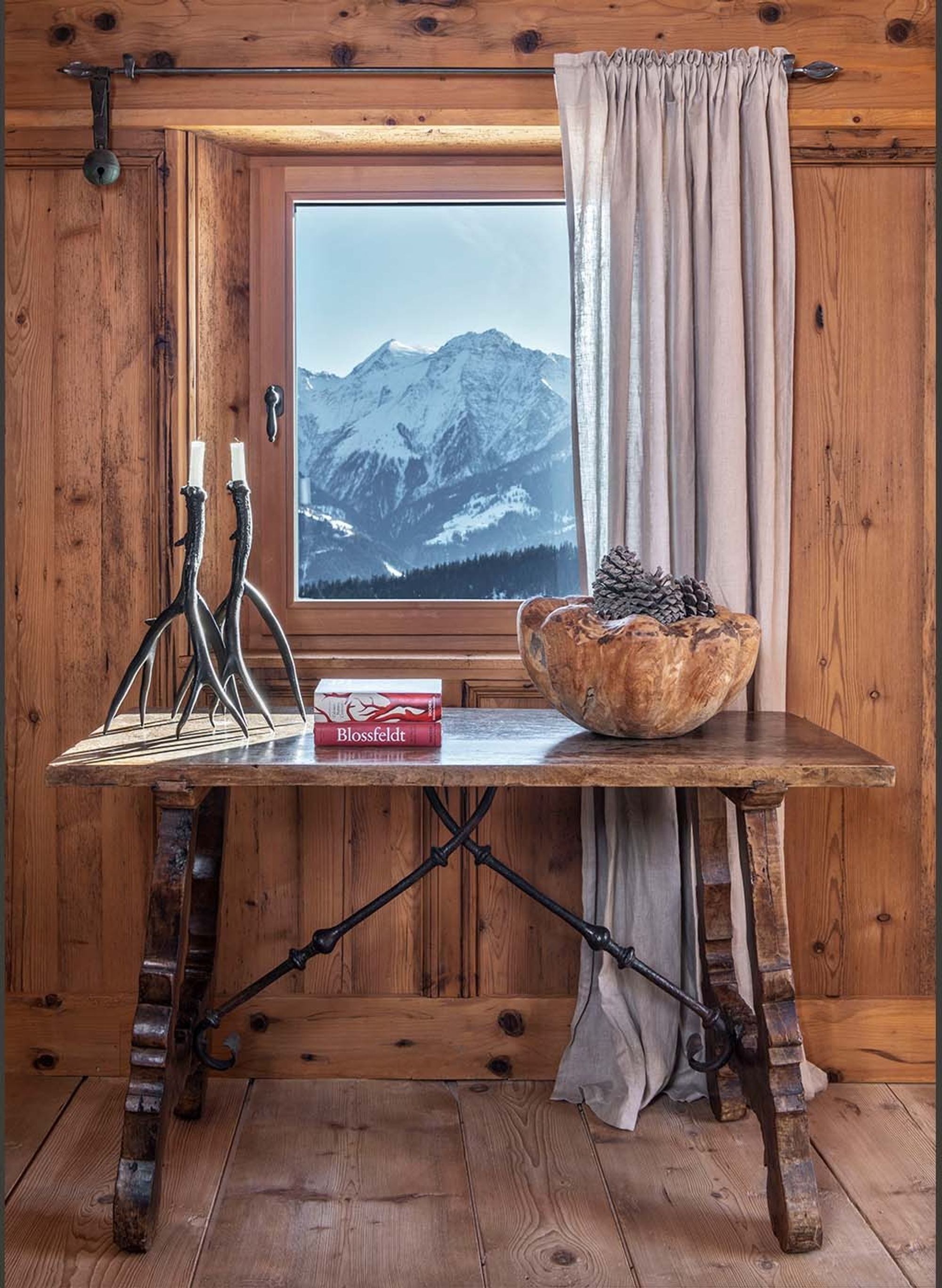 Timber table by the window with mountain view – Historic conversion in Fidaz