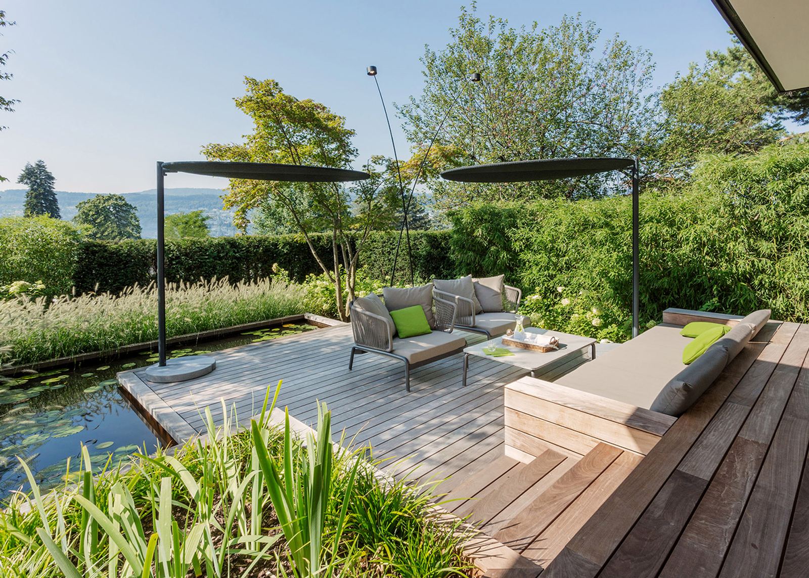 Timber deck by the water with sun sails