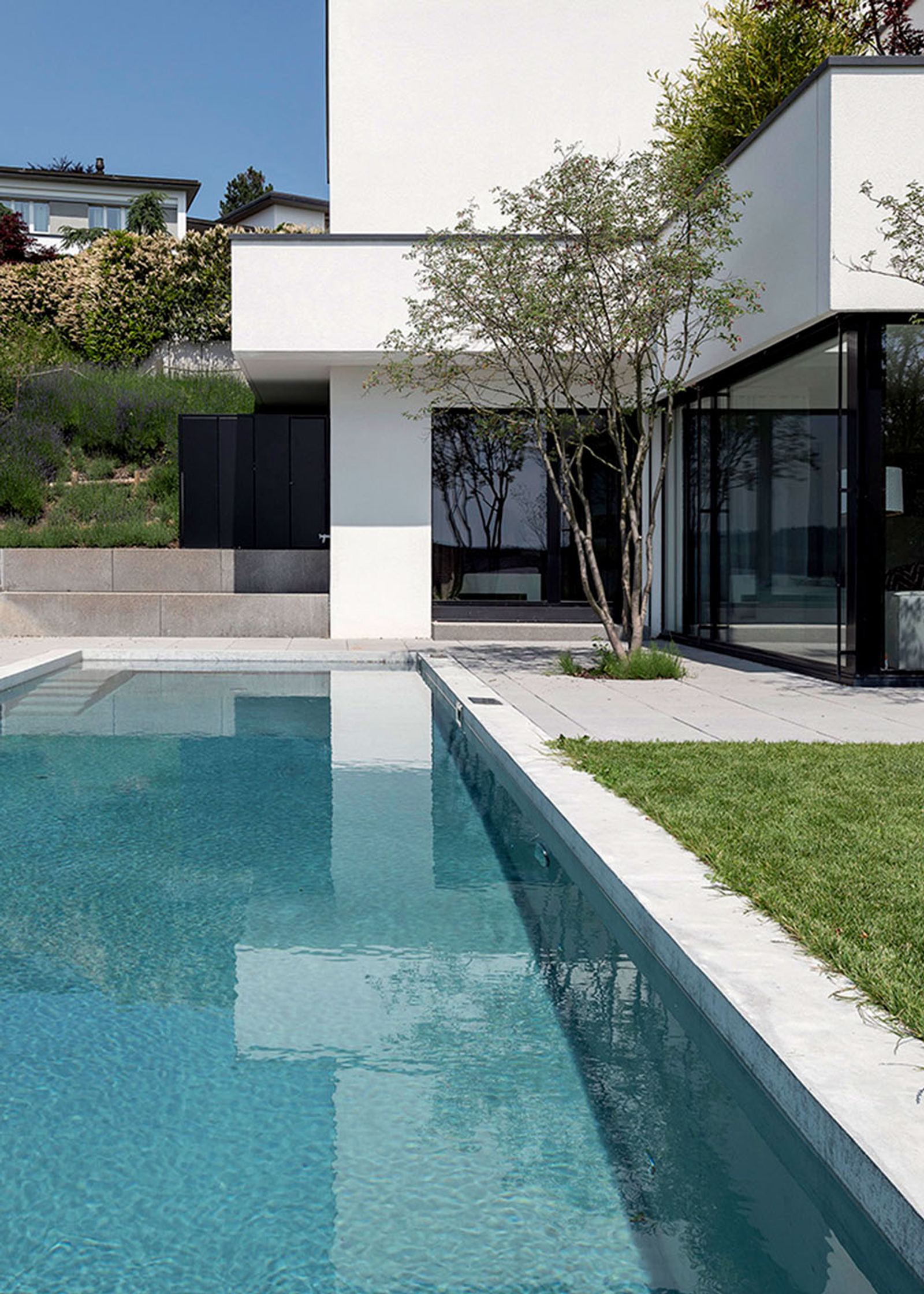 Narrow pool along the white facade
