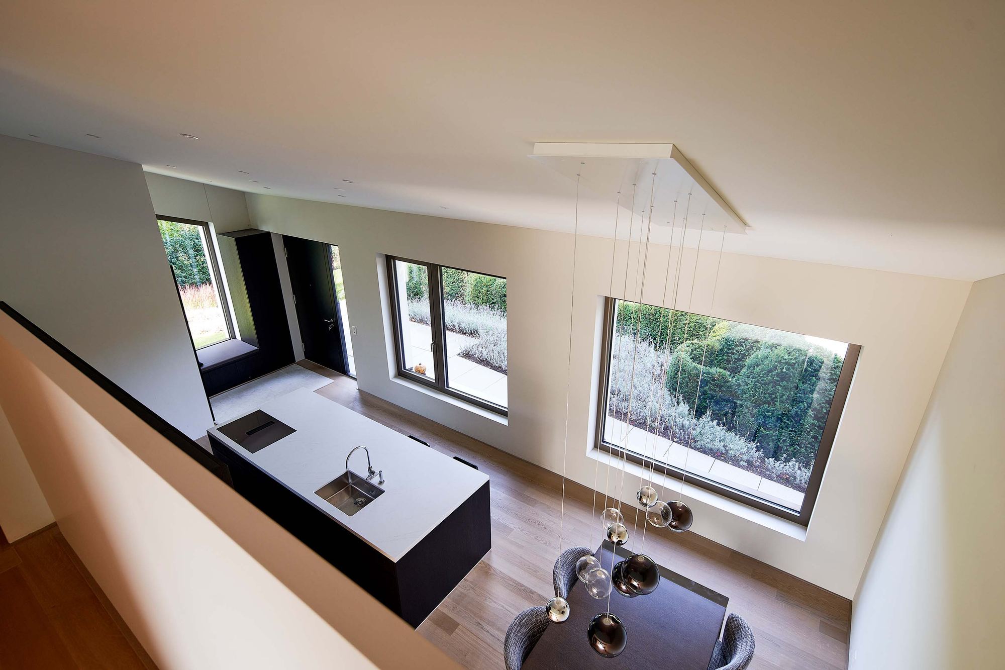 View from above into kitchen and dining area – Interiors and landscape, Zumikon
