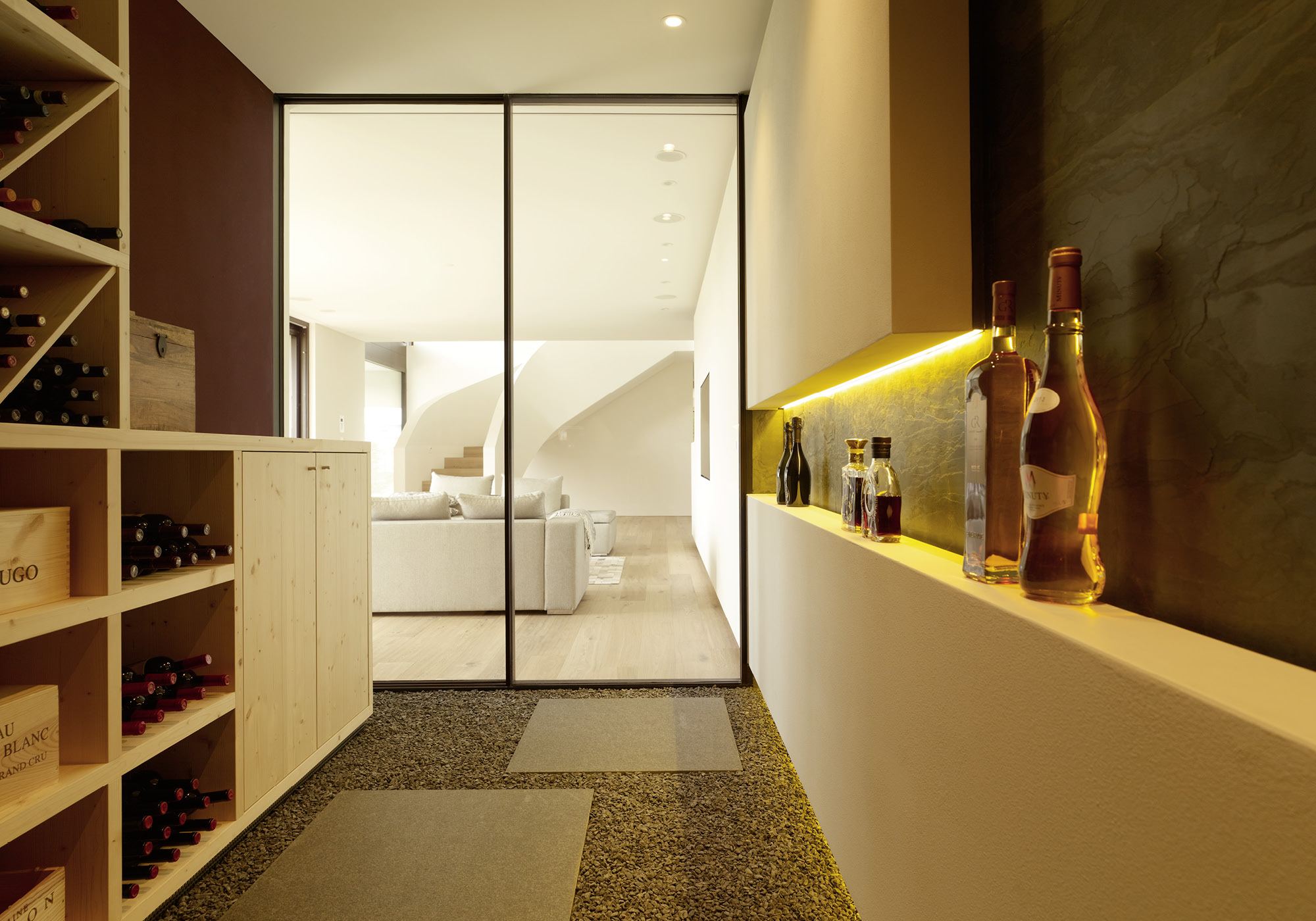 Wine cellar with timber racks and glass door – Single-family house in Oberwil-Lieli