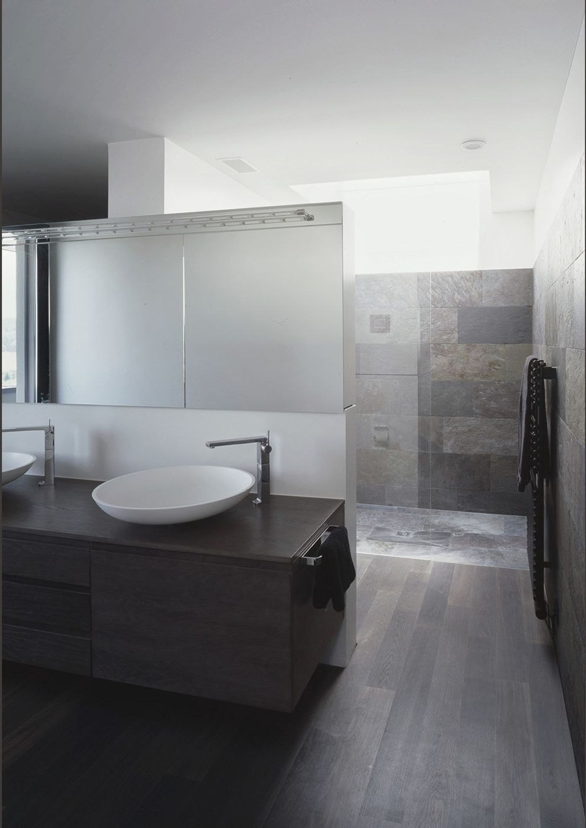 Vanity with countertop basin in front of a mirror – Single-family house in Bonstetten