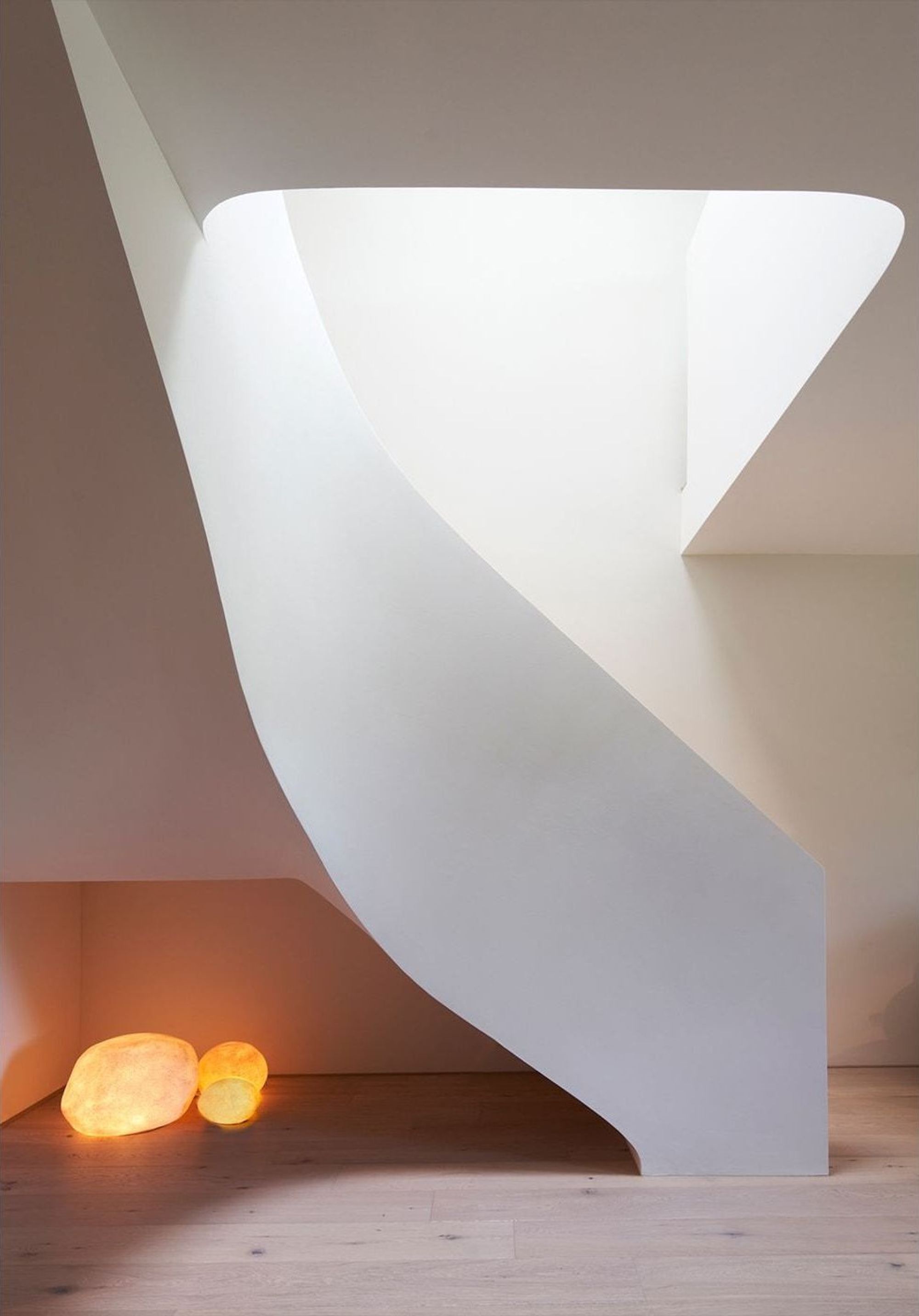 Underside of the curved staircase with glowing stones – Interiors and landscape, Wettswil