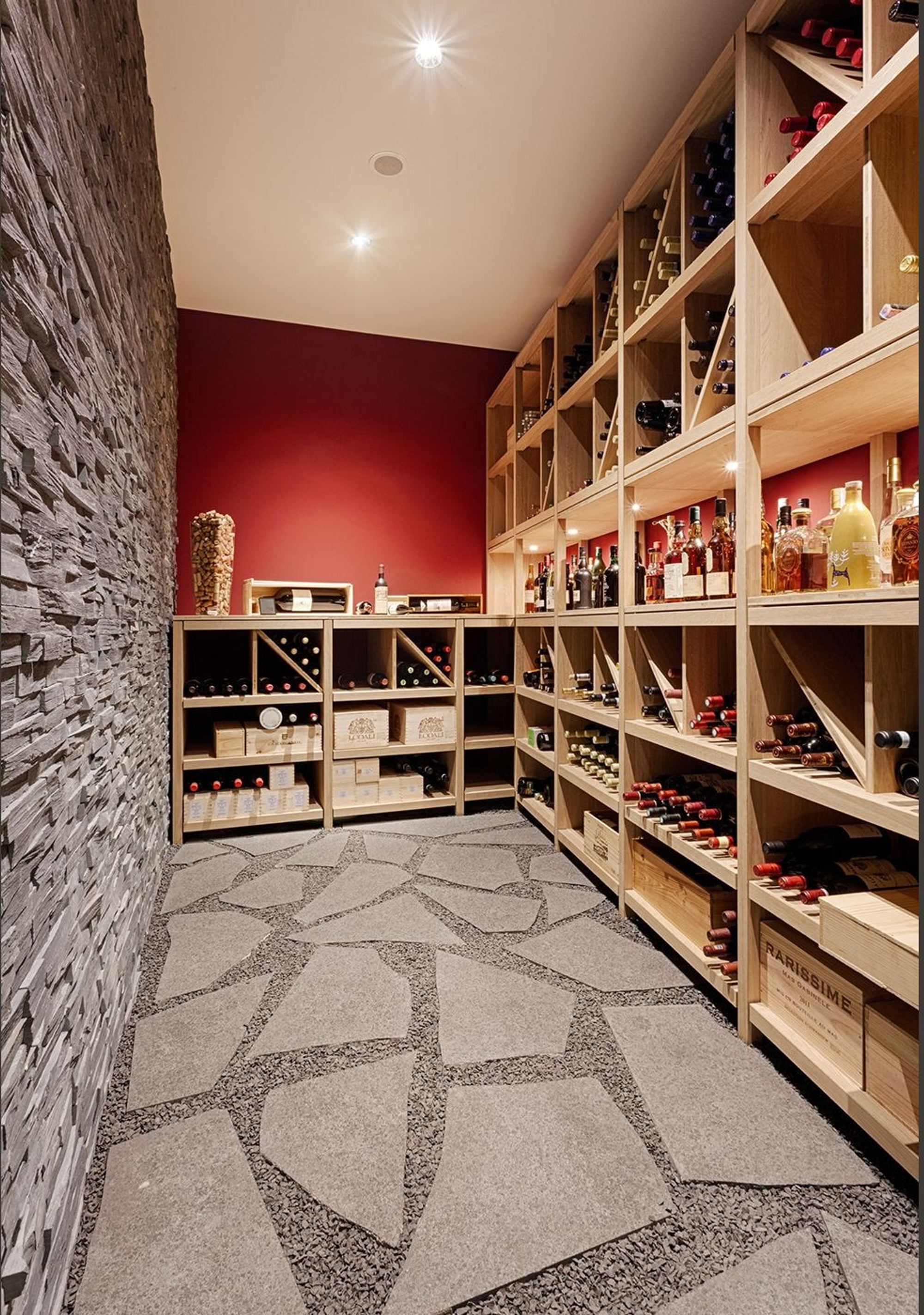 Wine cellar with timber shelving and stone floor – Single-family house in Uitikon