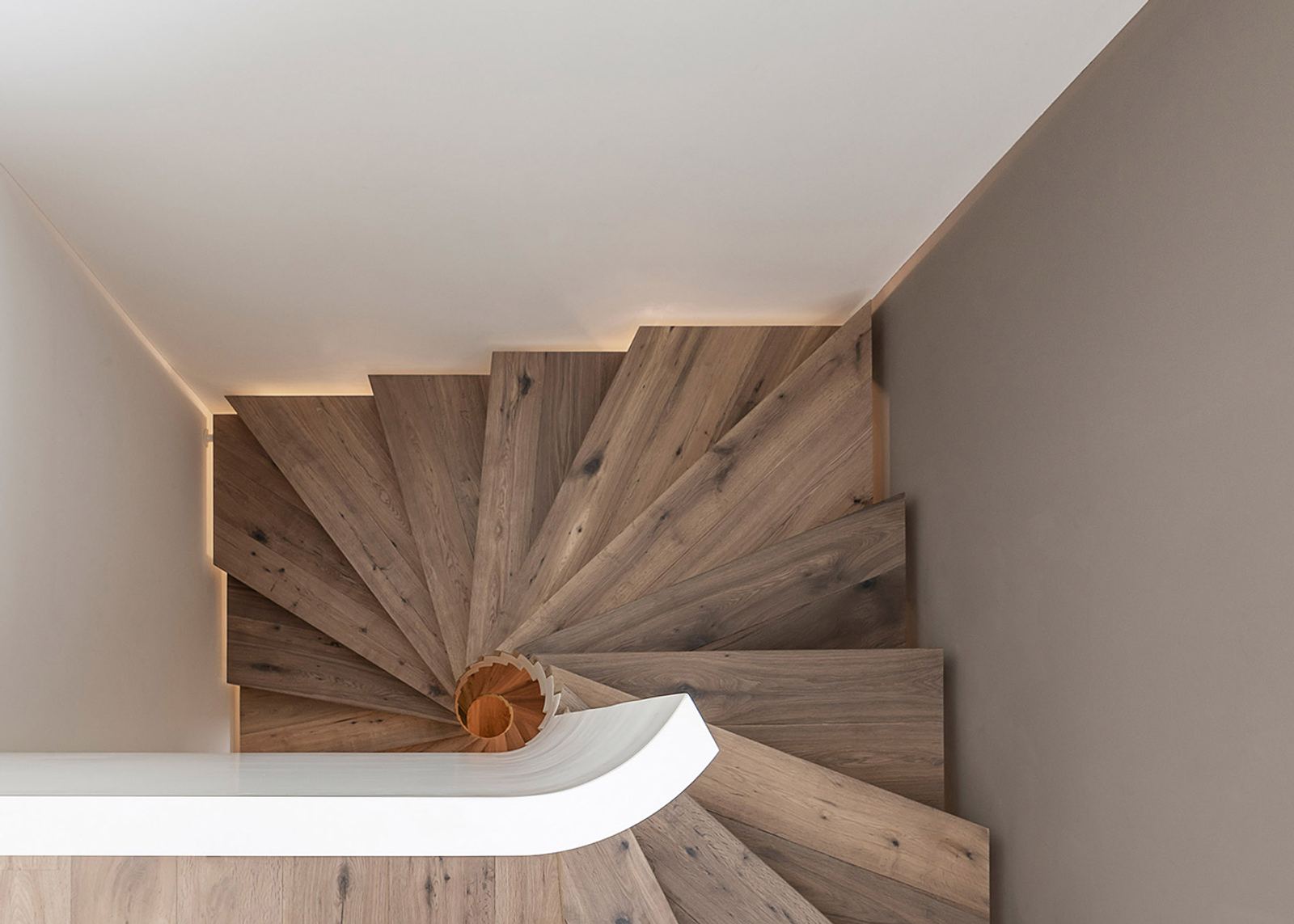 Looking down onto a winding timber staircase