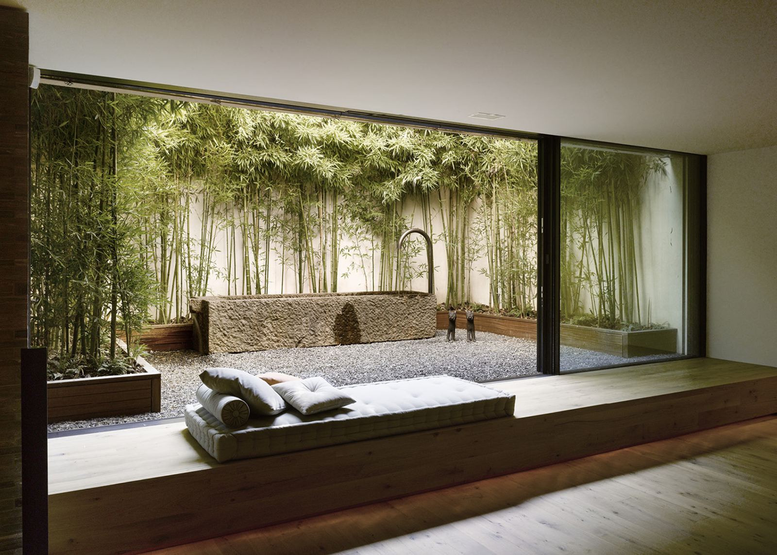 Room with glass front to the bamboo courtyard
