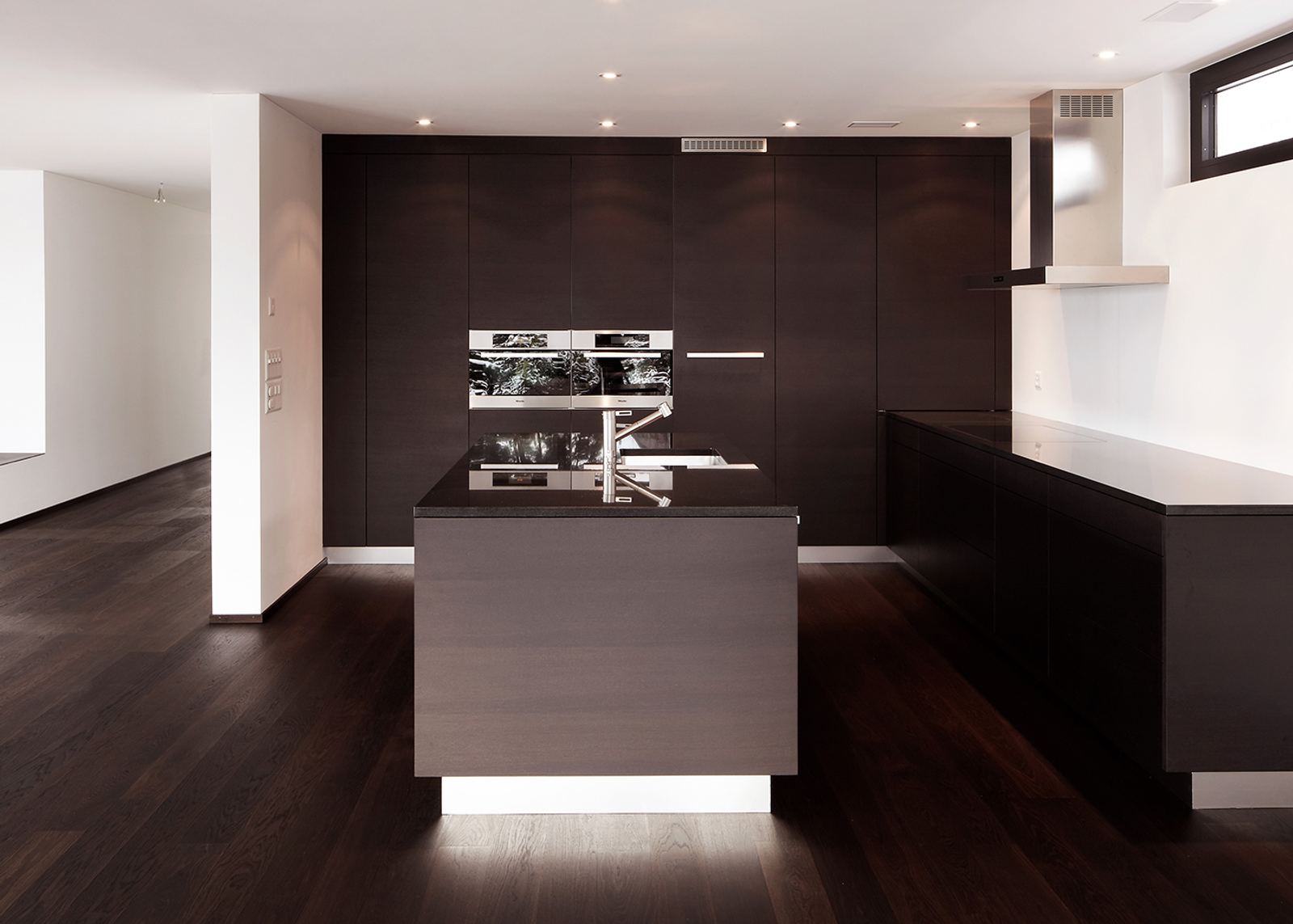 Dark kitchen with illuminated island base