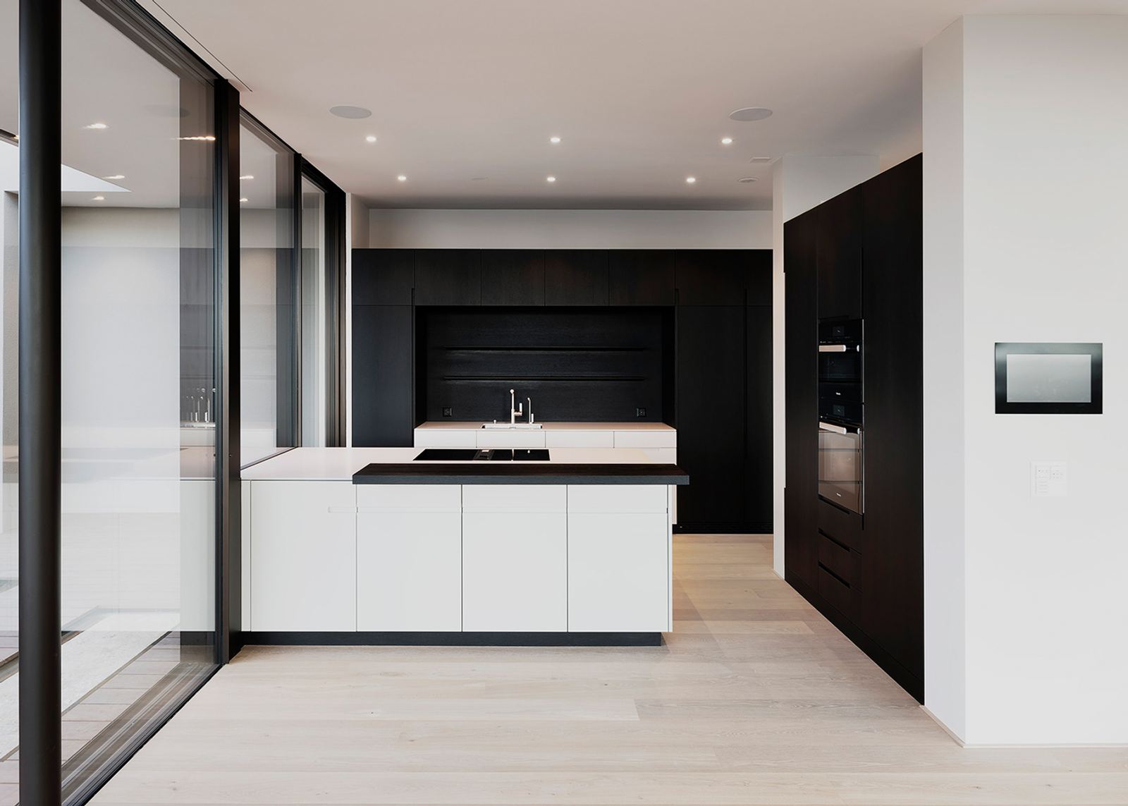 White island in front of dark tall cabinets
