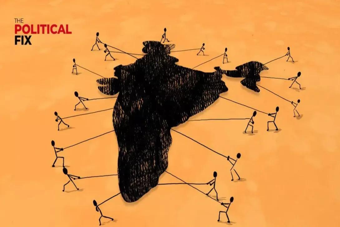 A dark, textured map of India surrounded by stick figures pulling on its borders with ropes. Text: 'THE POLITICAL FIX'.
