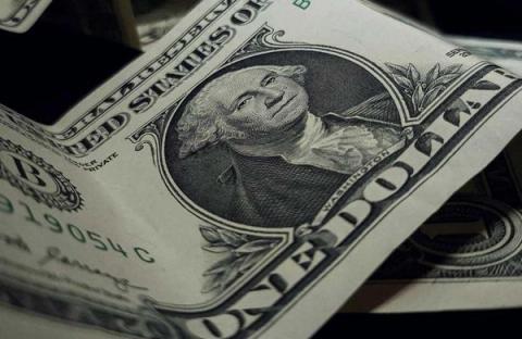 Close-up of a crumpled one-dollar bill.