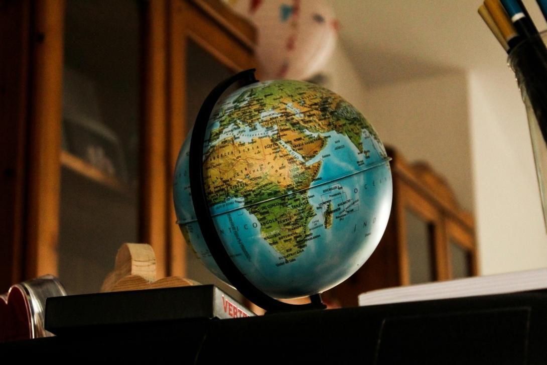 A world globe showing Africa, Europe, and Asia.