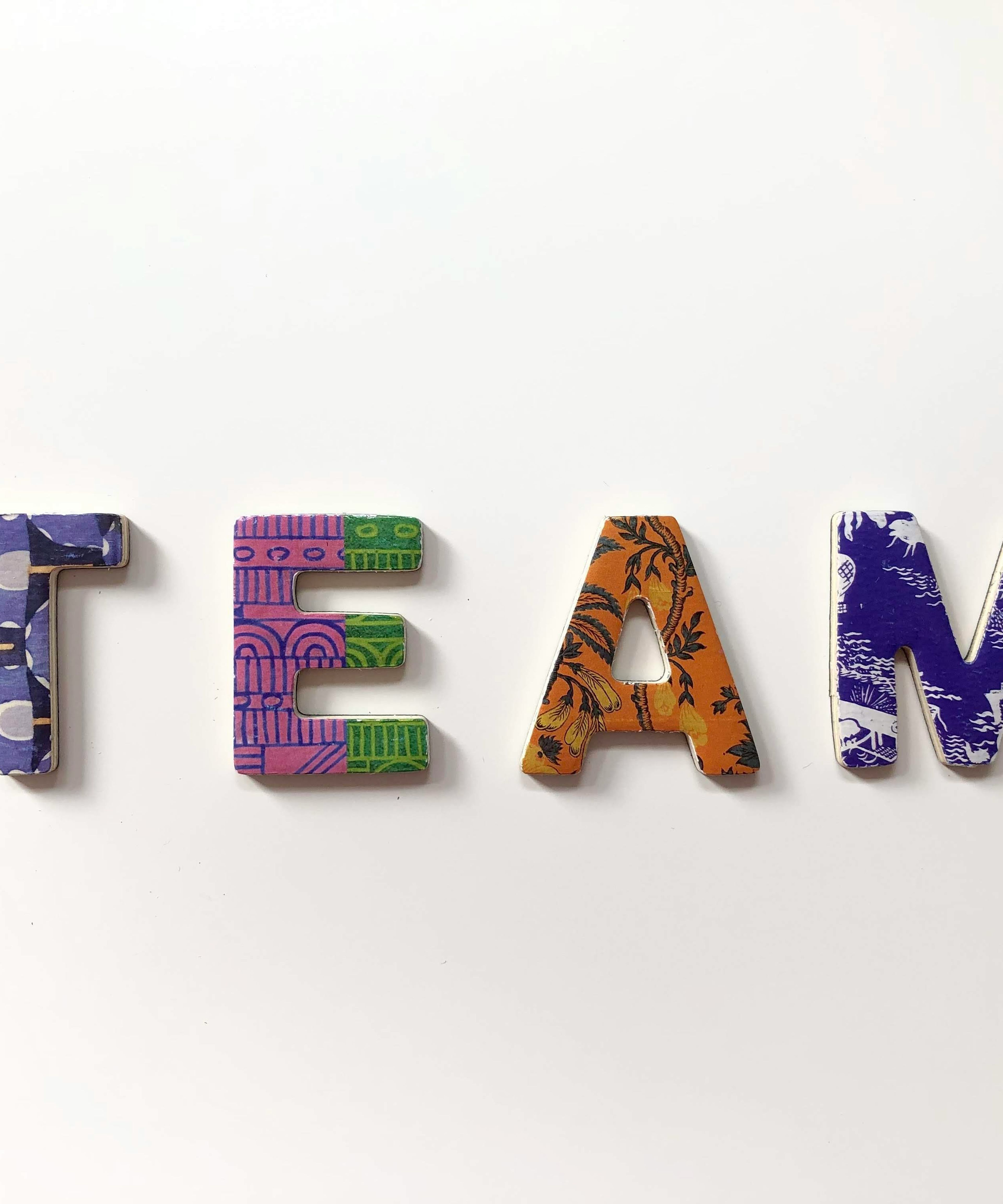 Silhouettes of several people against a blue sky.