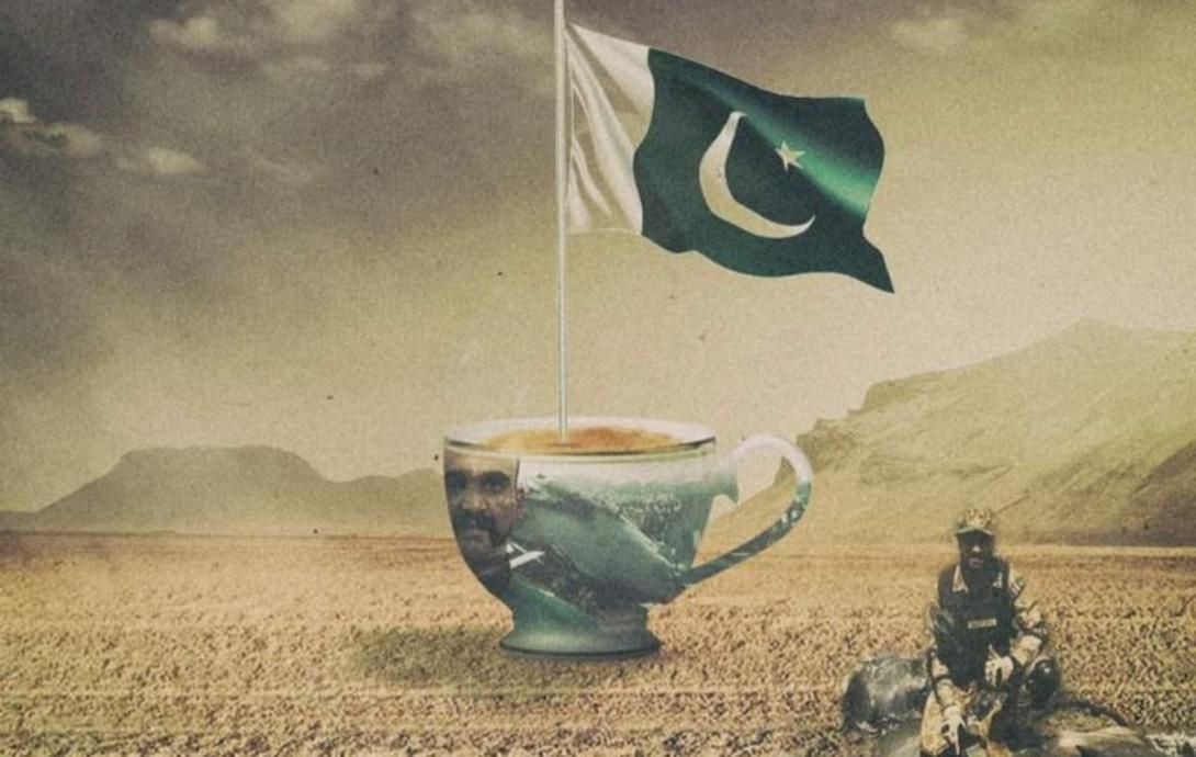 A Pakistani flag flies above a large teacup in a desert, containing a fighter jet and the face of Abhinandan Varthaman, with a soldier kneeling nearby.