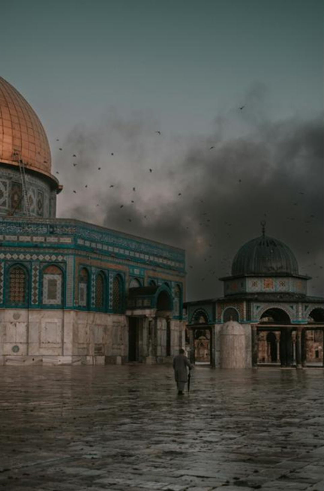 The golden-domed Dome of the Rock and another historic building under a dark, bird-filled sky, with a lone figure walking on wet ground.