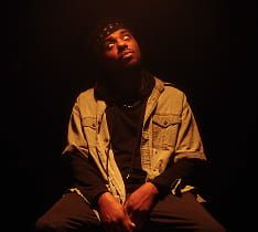 Person by water with city skyline