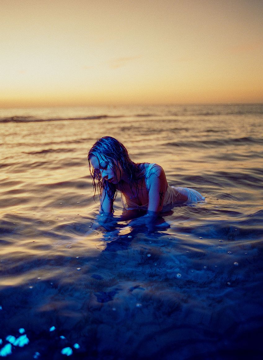 Person on beach with blue fabric