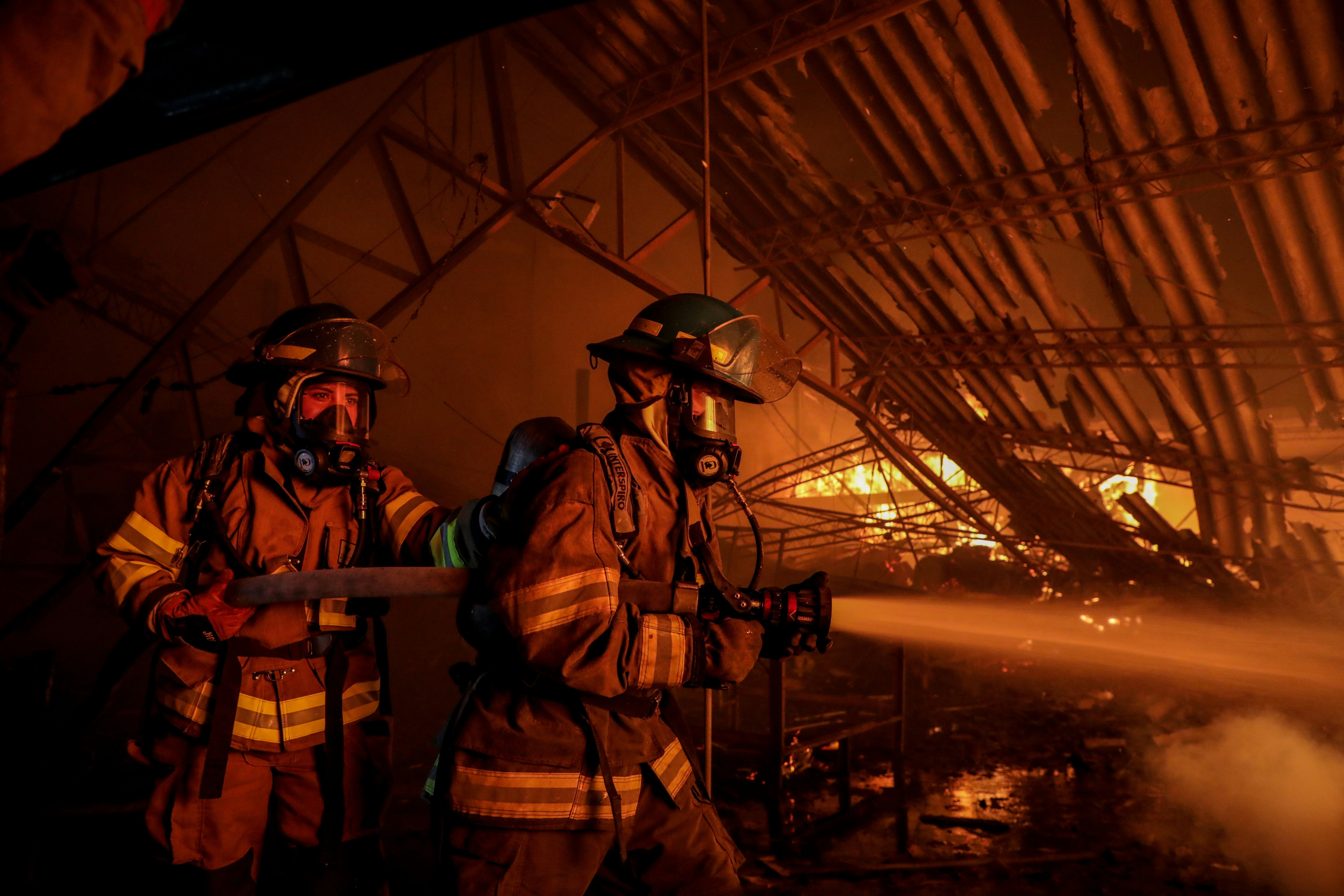 Firefighters battling a large blaze inside a building