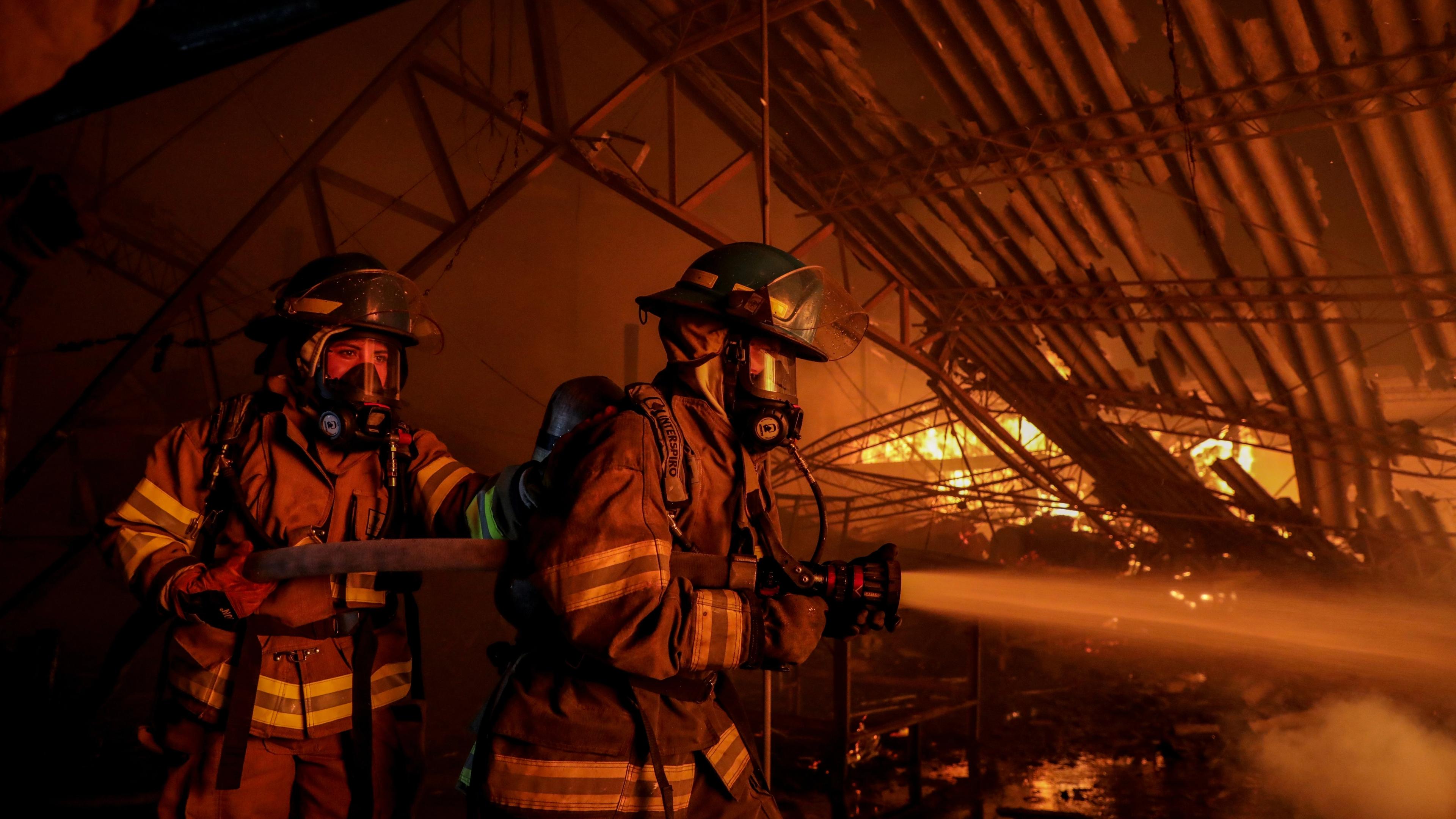 Firefighters battling a large blaze inside a building