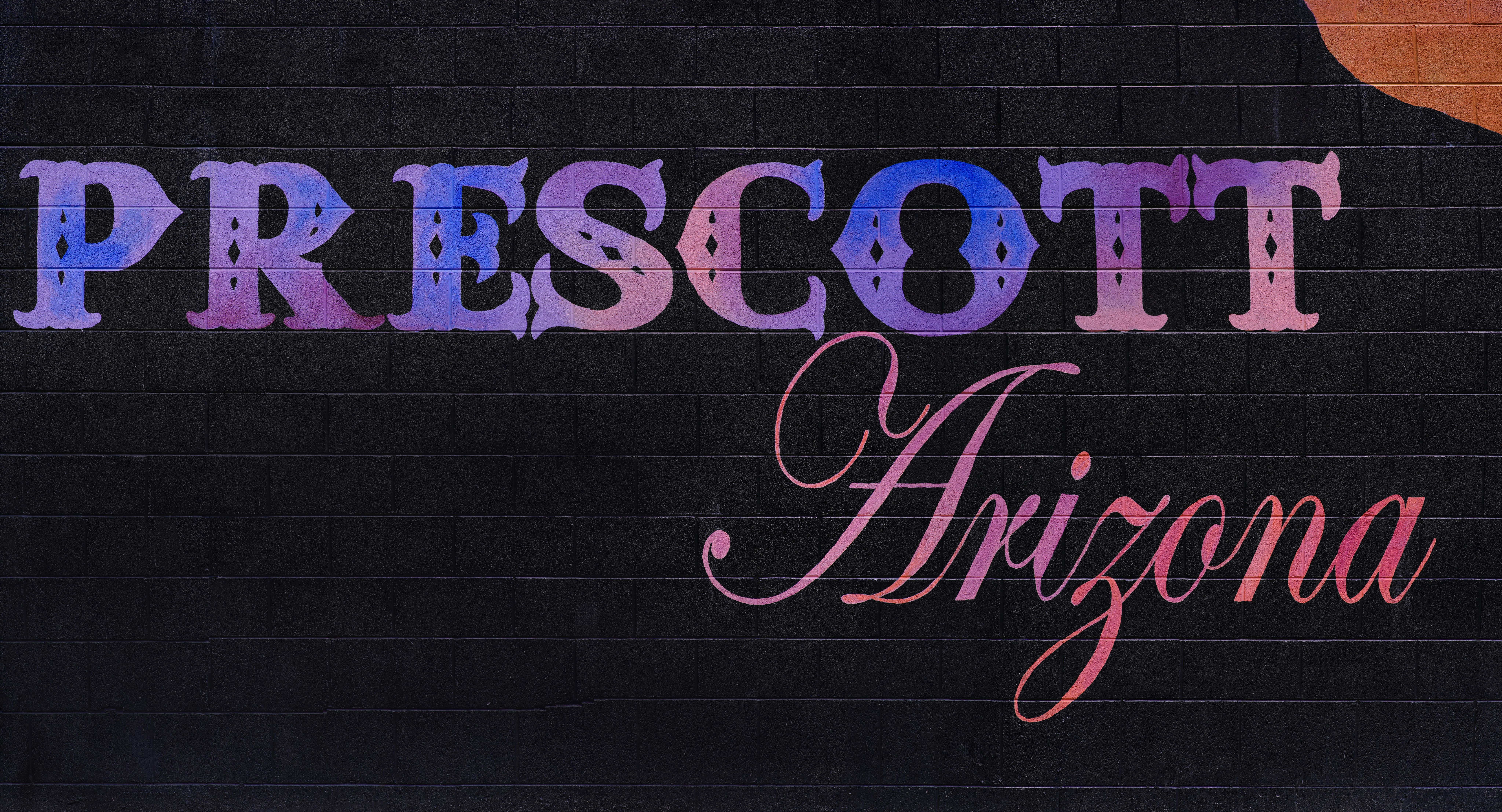 A sign that says prescot arizona with a guitar on it