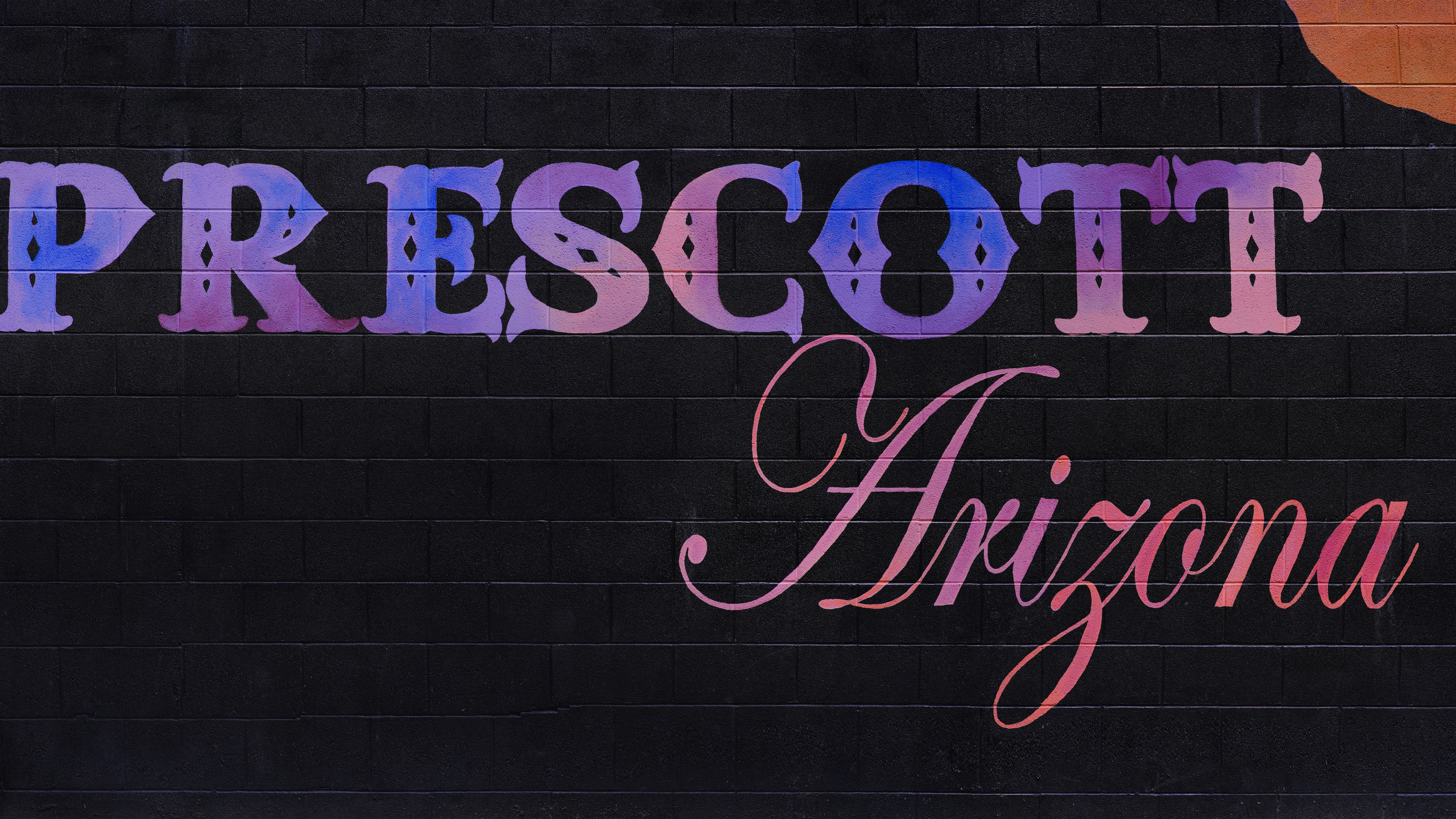 A sign that says prescot arizona with a guitar on it
