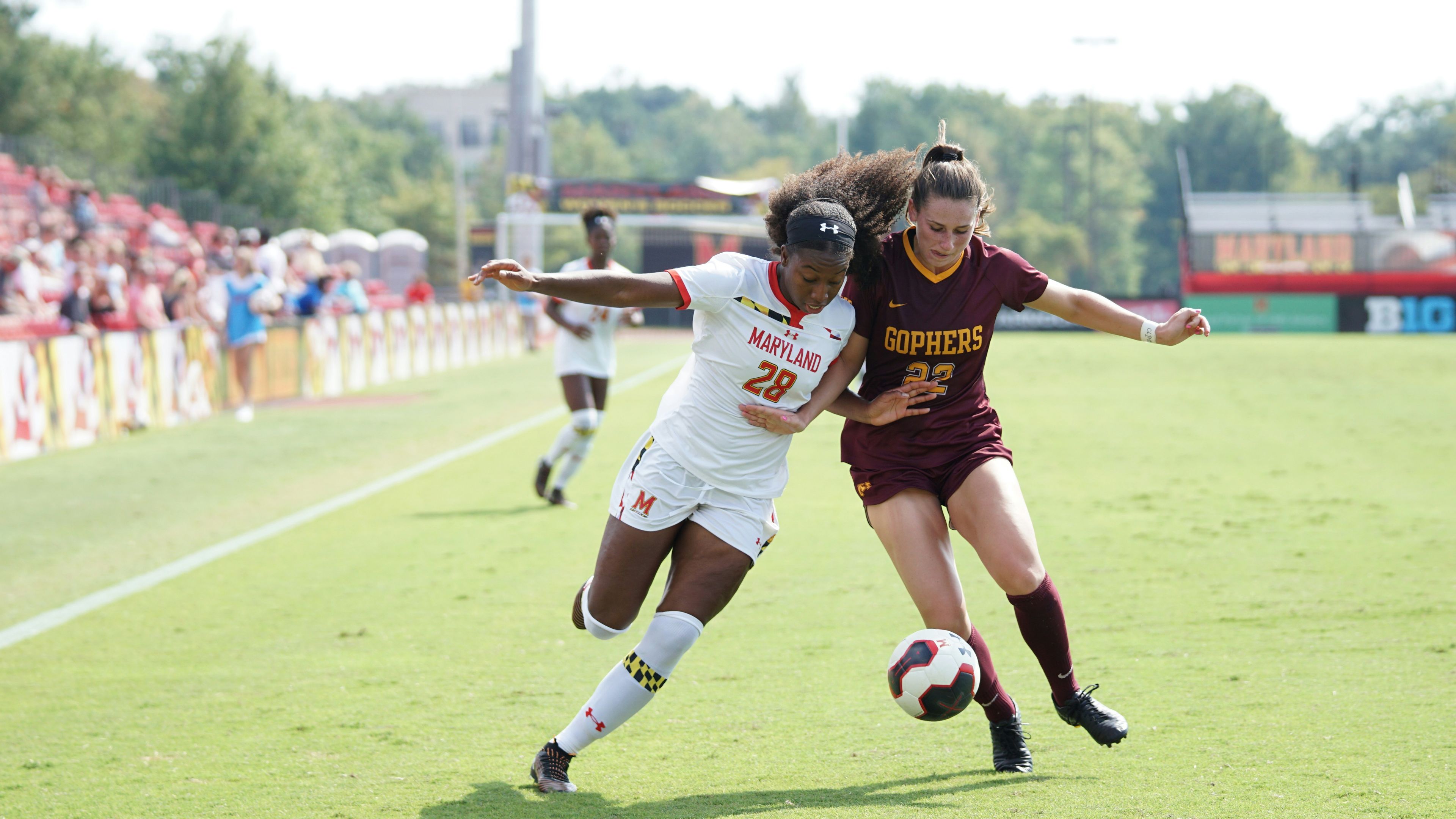 Women playing soccer during day