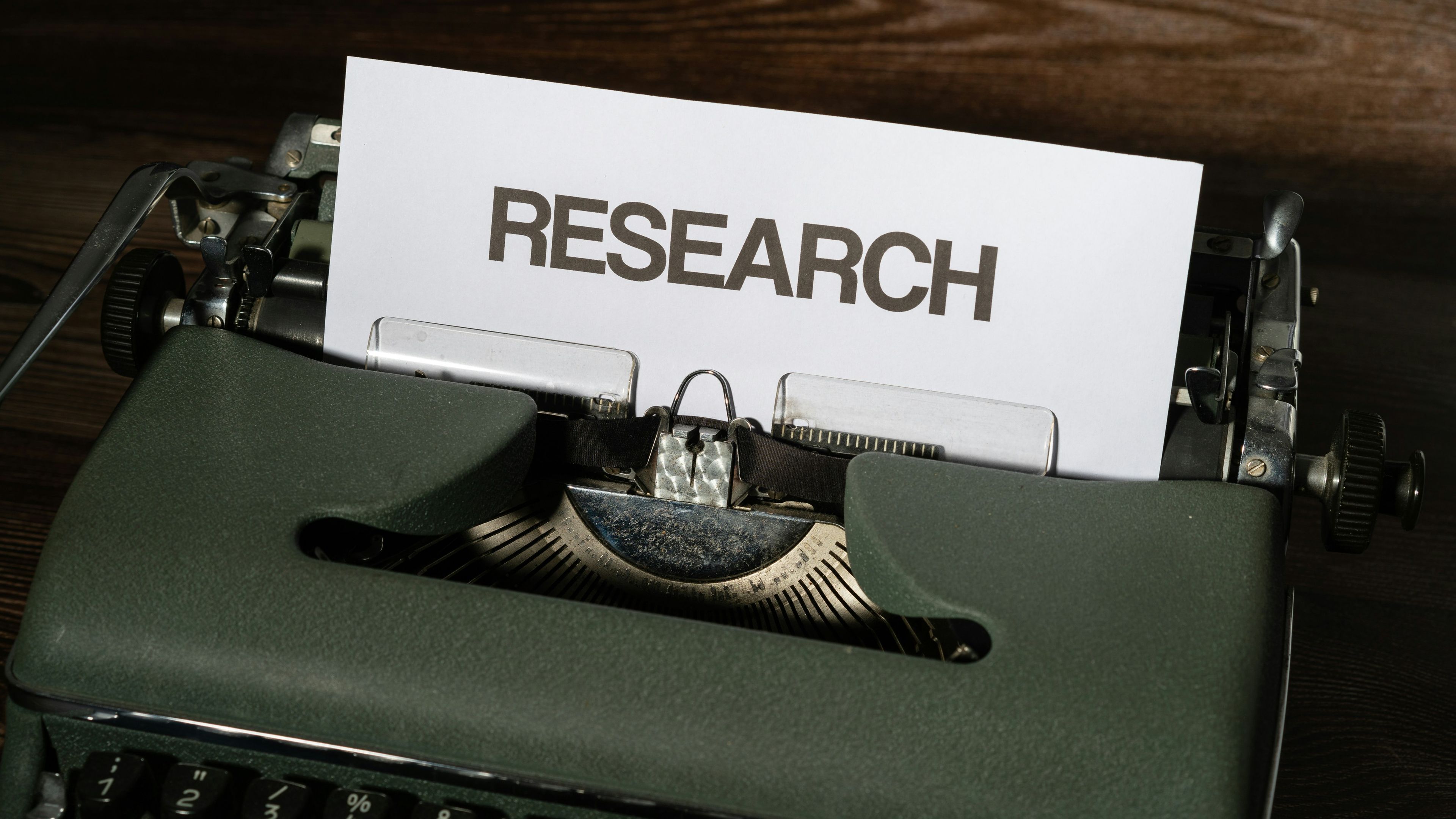 A close up of a typewriter with a paper on it