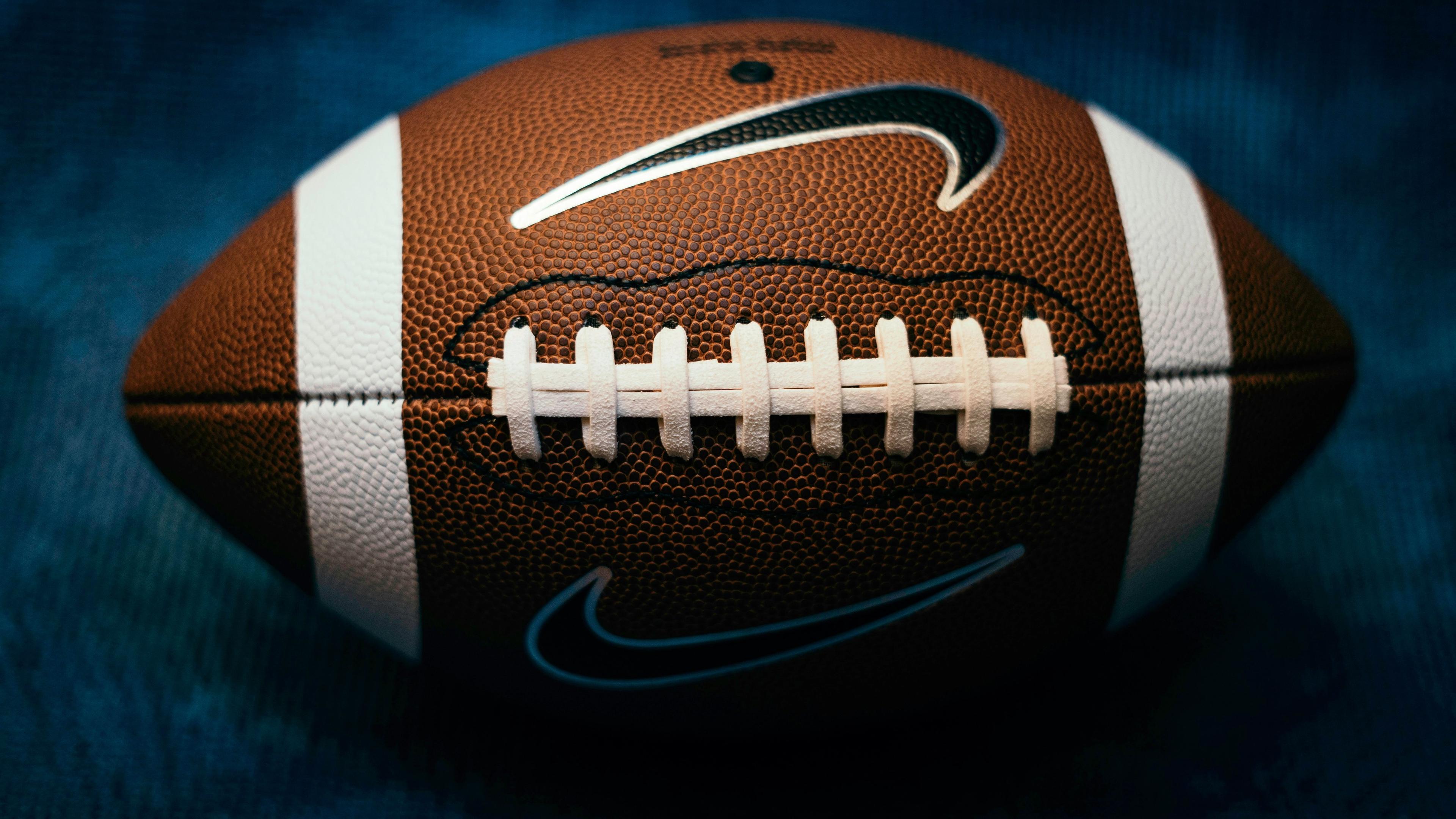 A close up of a football on a blue background