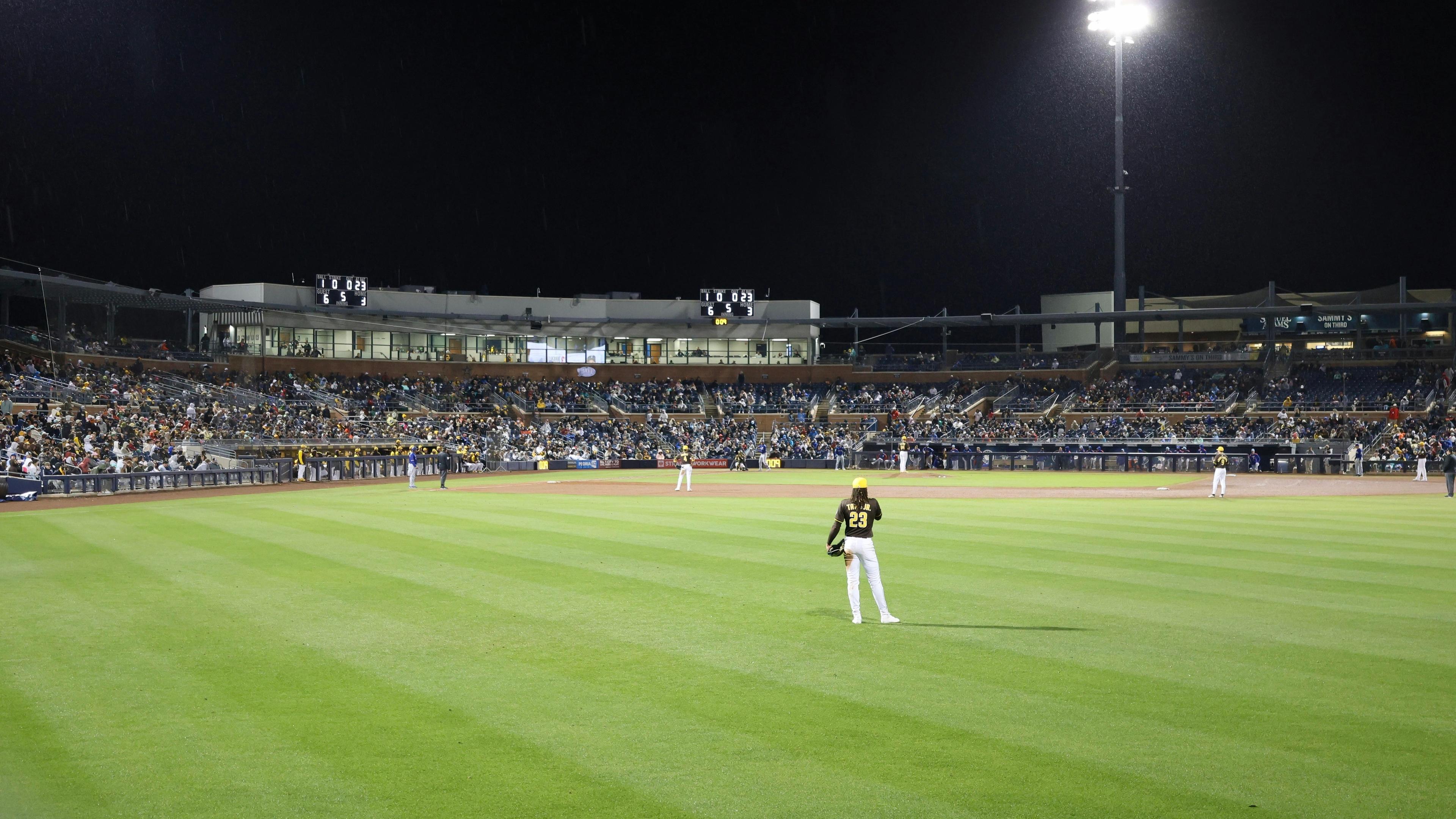 A baseball game is taking place at night
