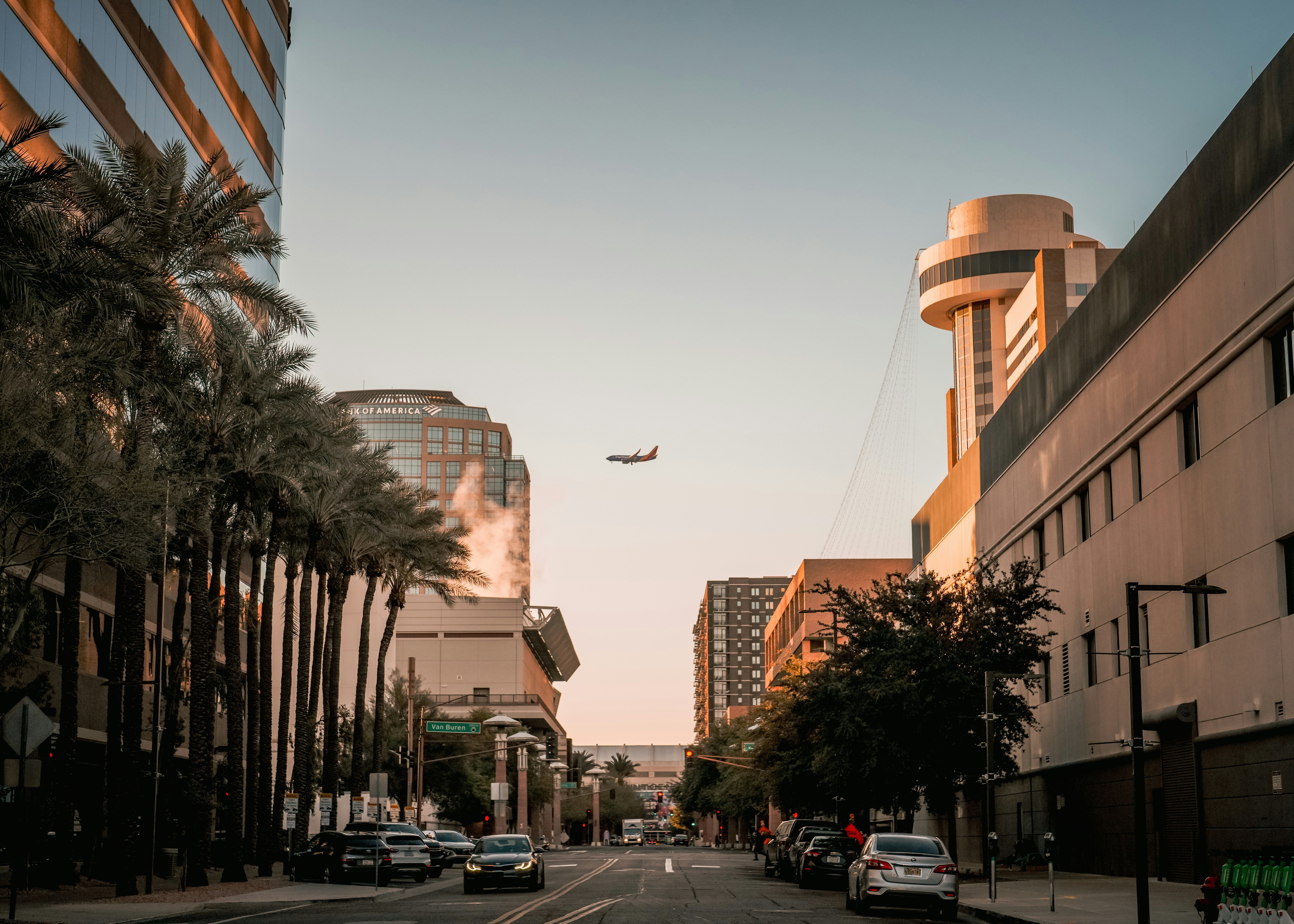 An airplane is flying over a city street
