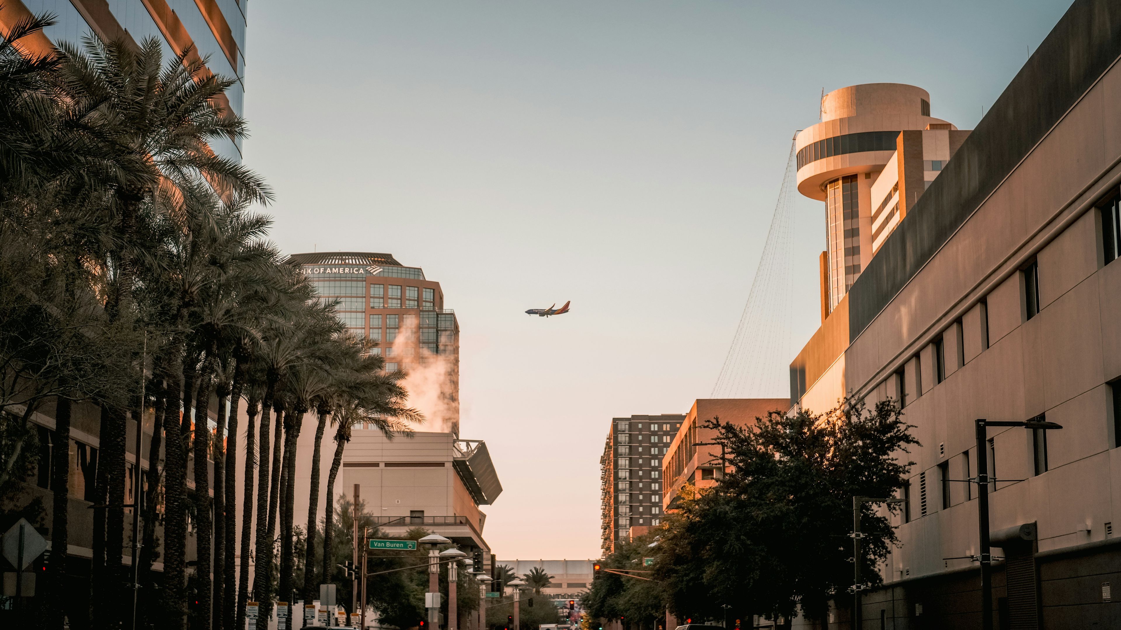 An airplane is flying over a city street