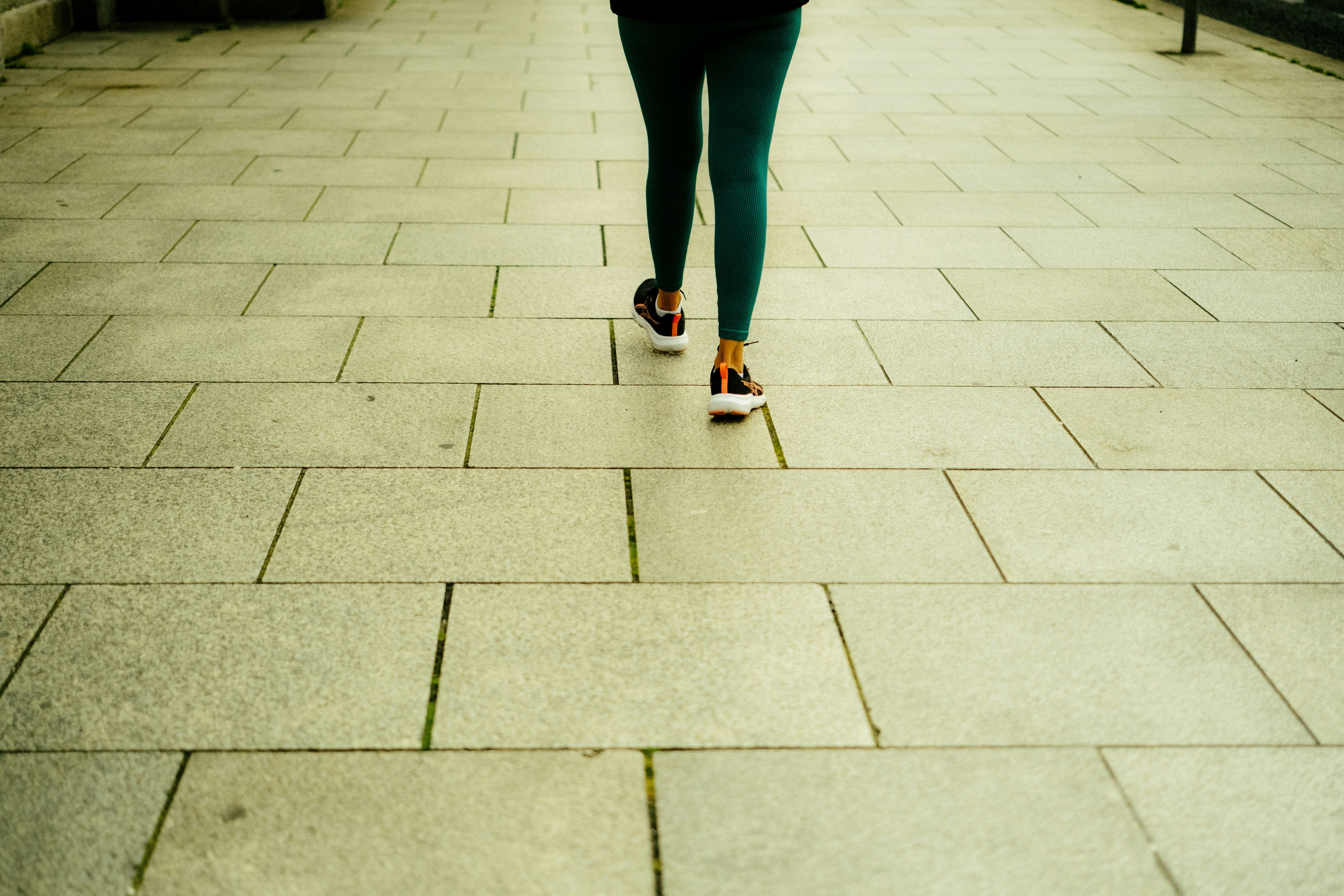 Person walking on a tiled path