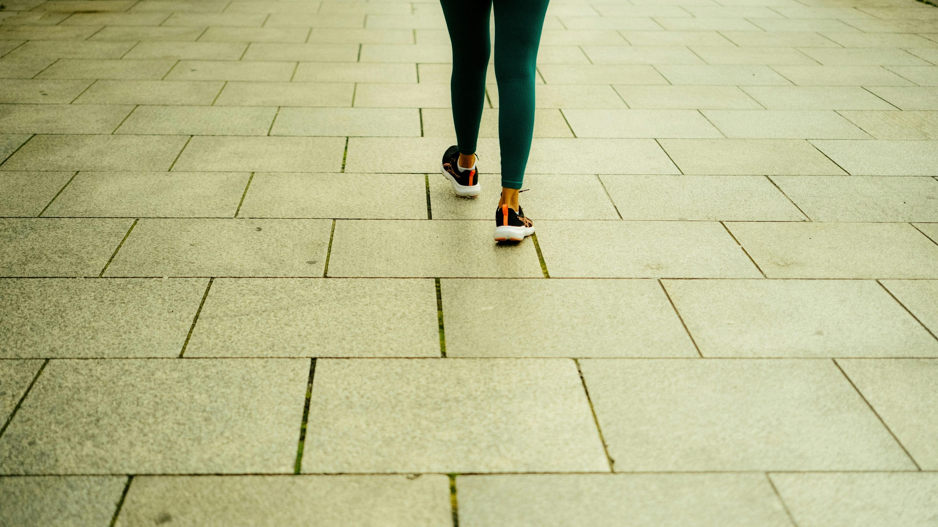 Person walking on a tiled path