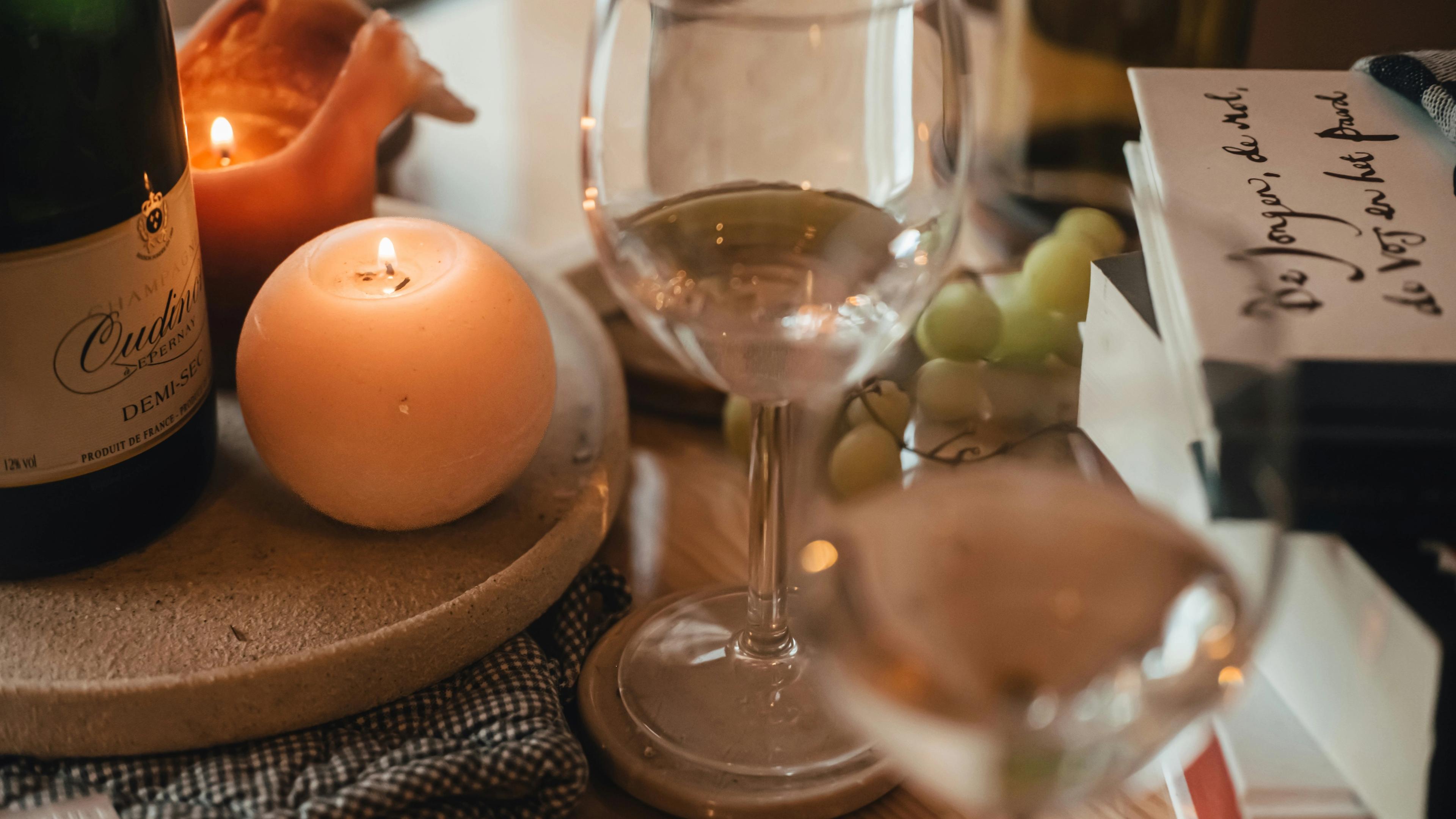 A glass of wine next to a table full of food