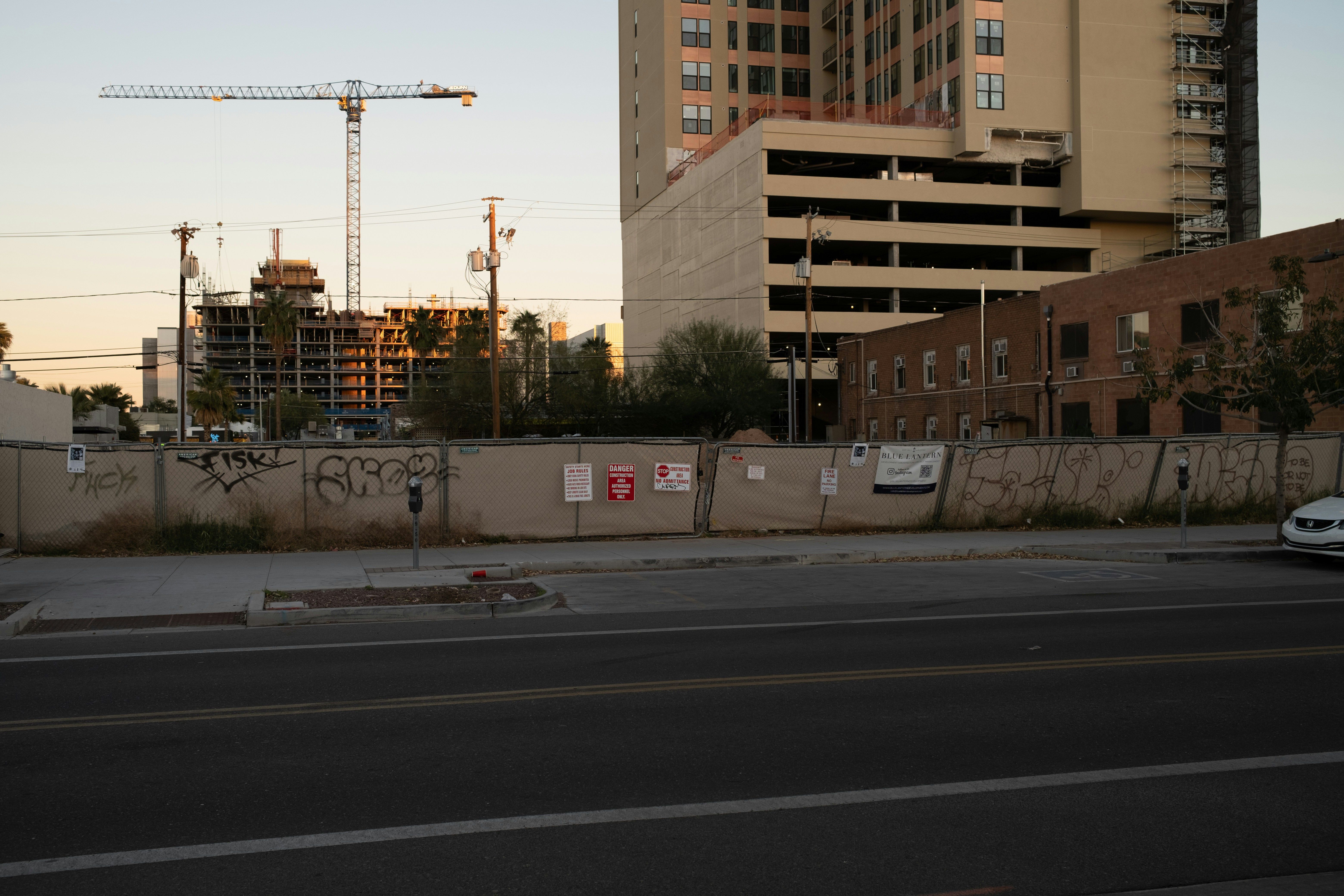 A city street with a construction site in the background