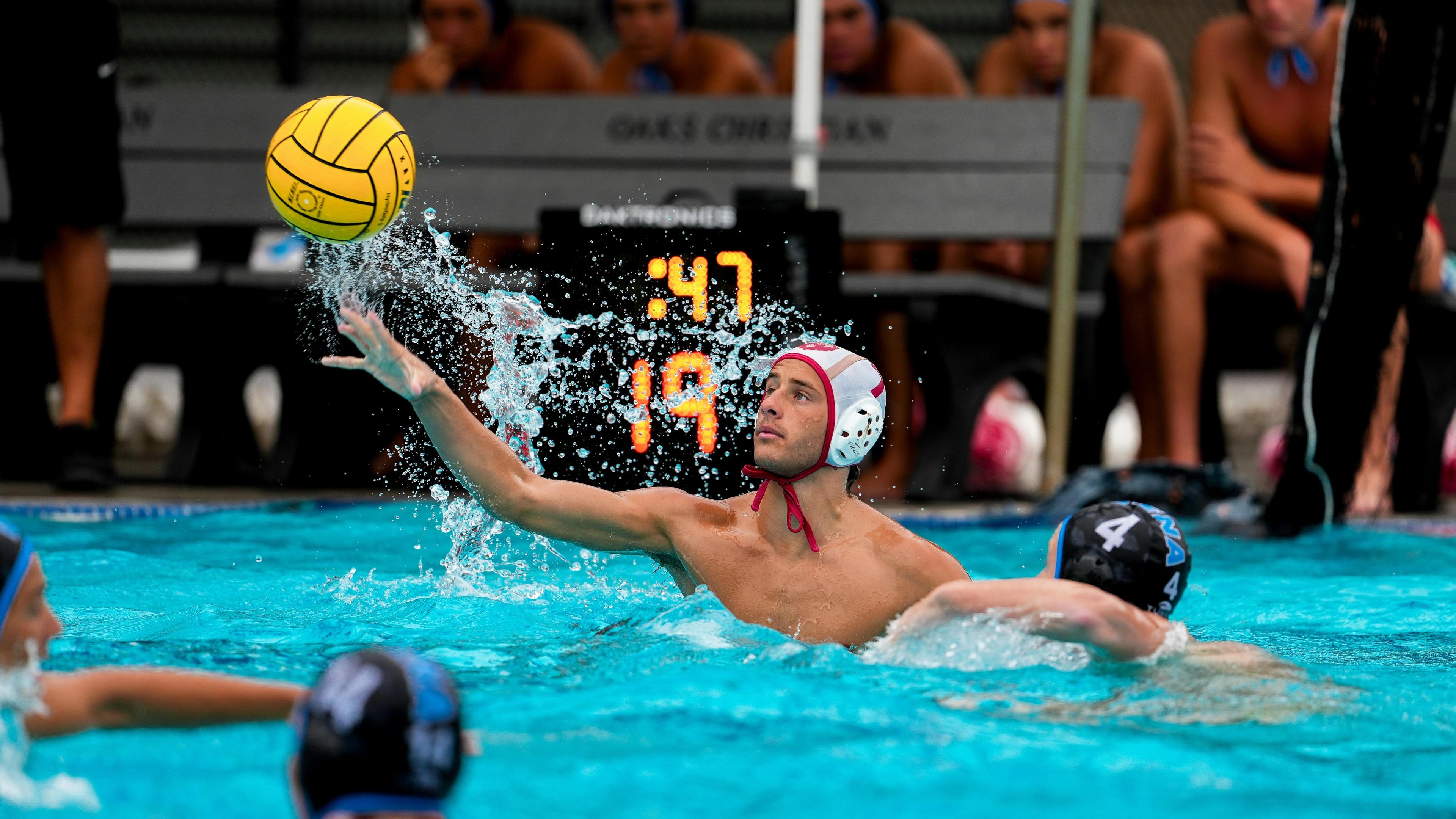 Water polo player throws ball during game