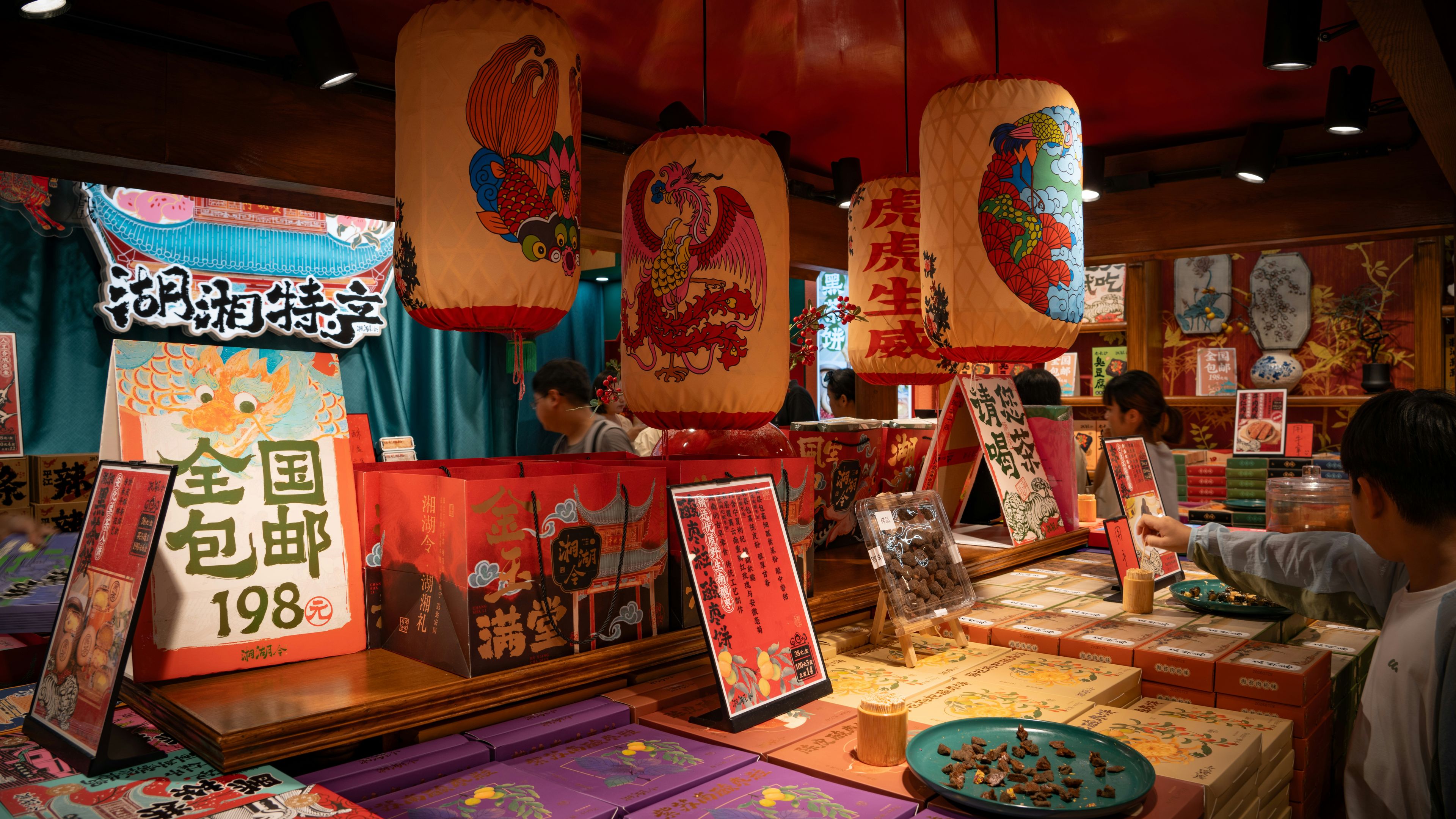 A shop interior with hanging paper lanterns and boxes of food products on display