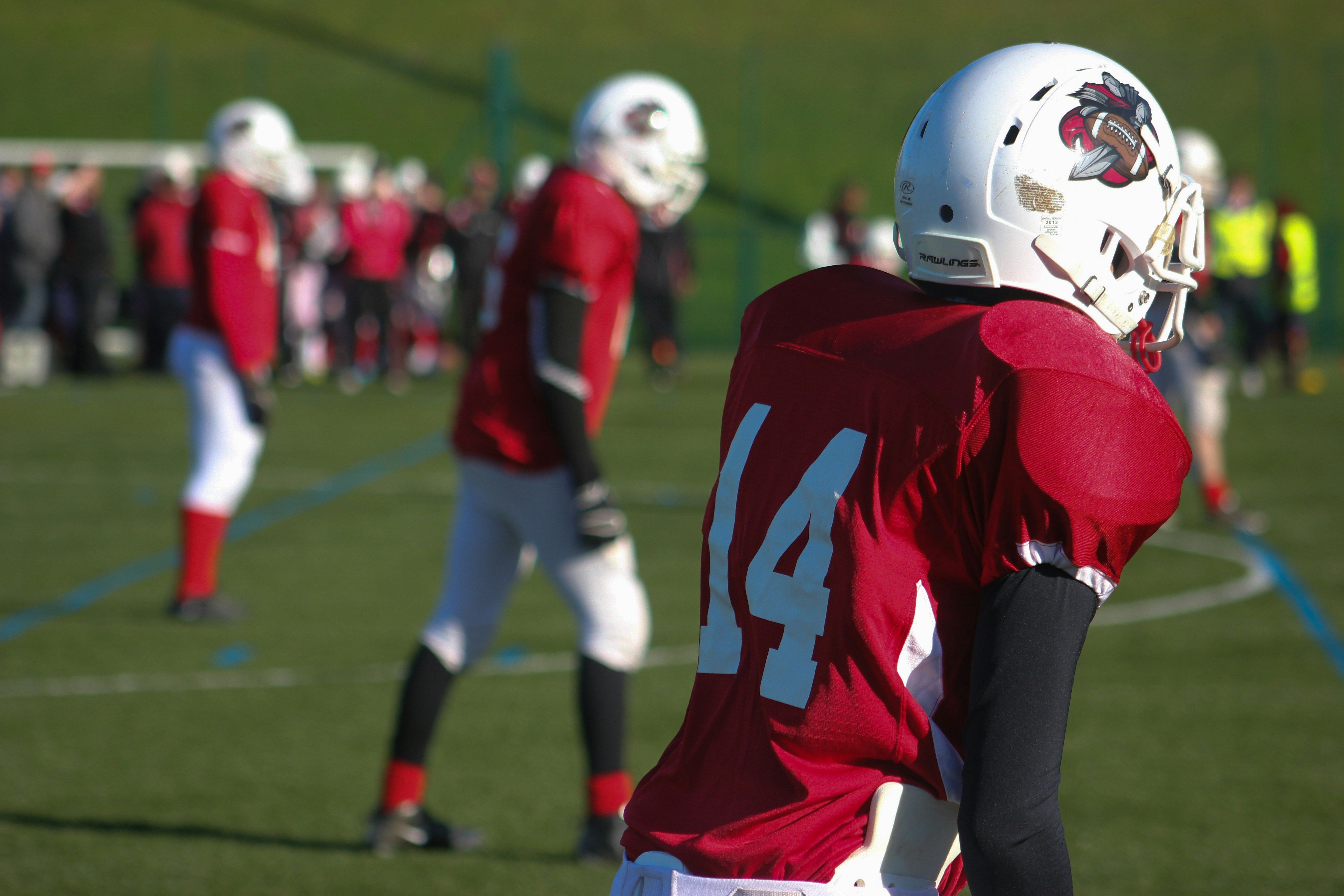 Selective focus photography of American football 14 player