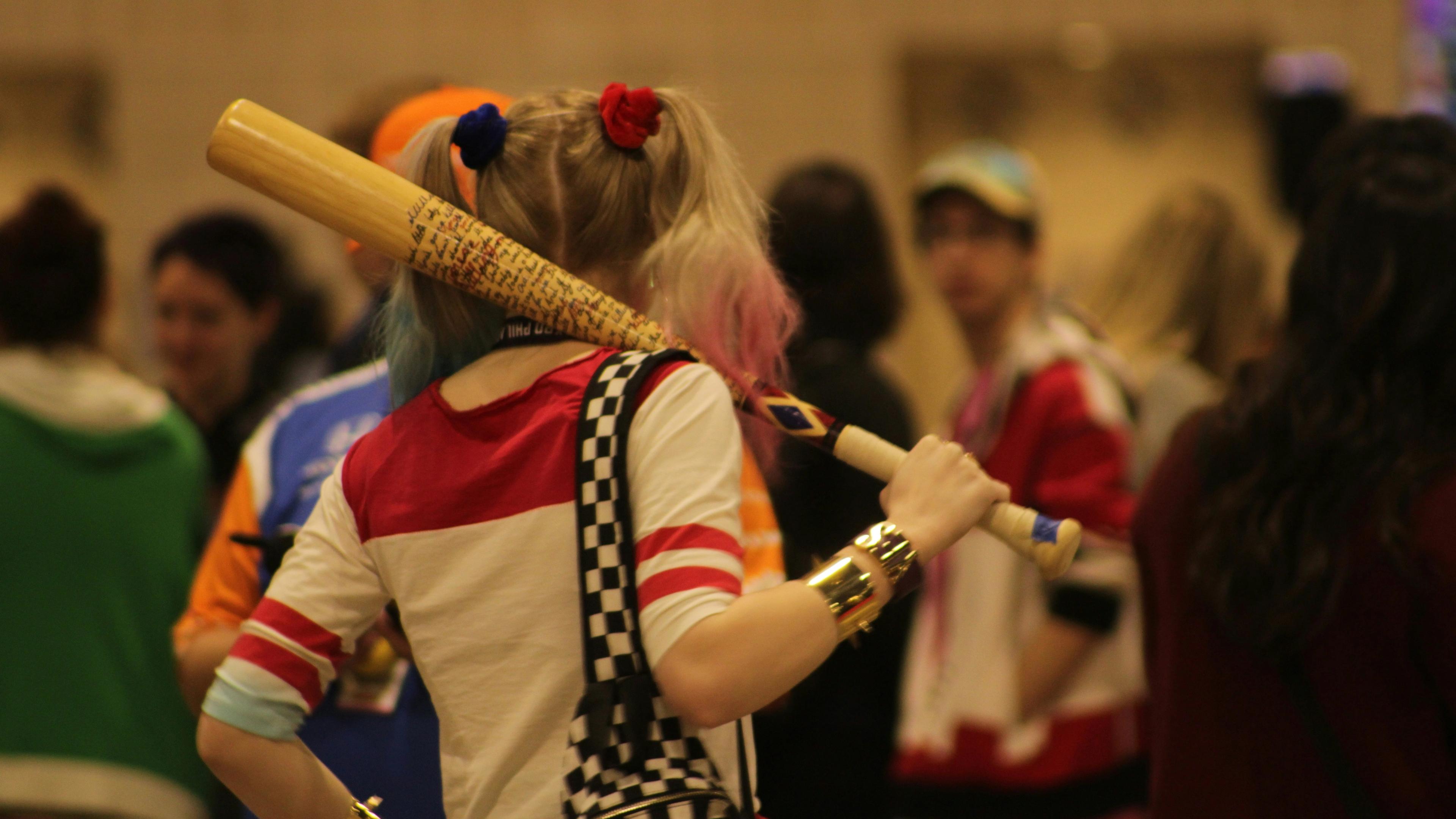 A woman with a baseball bat in her hand