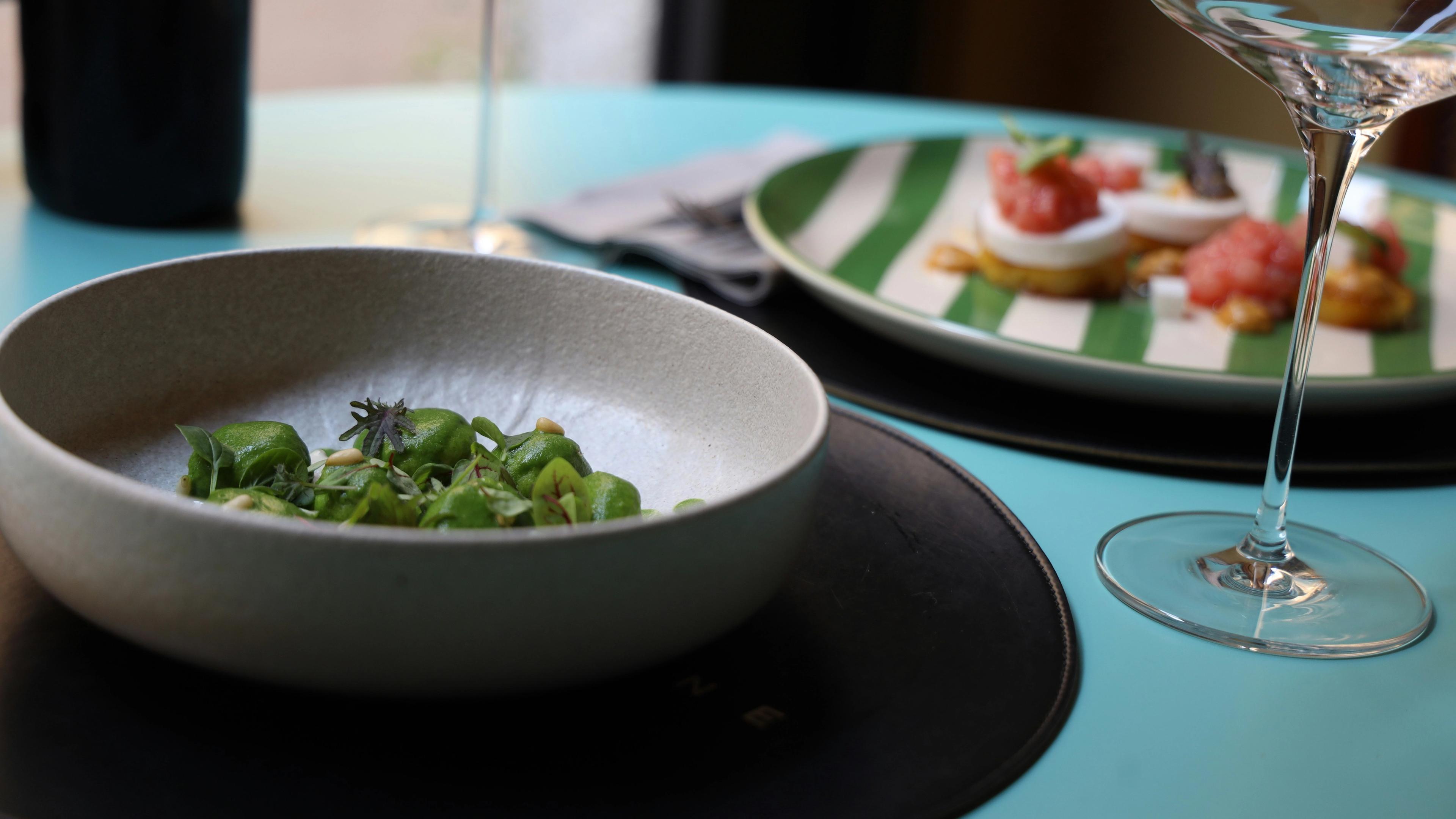Green food in a bowl on a table