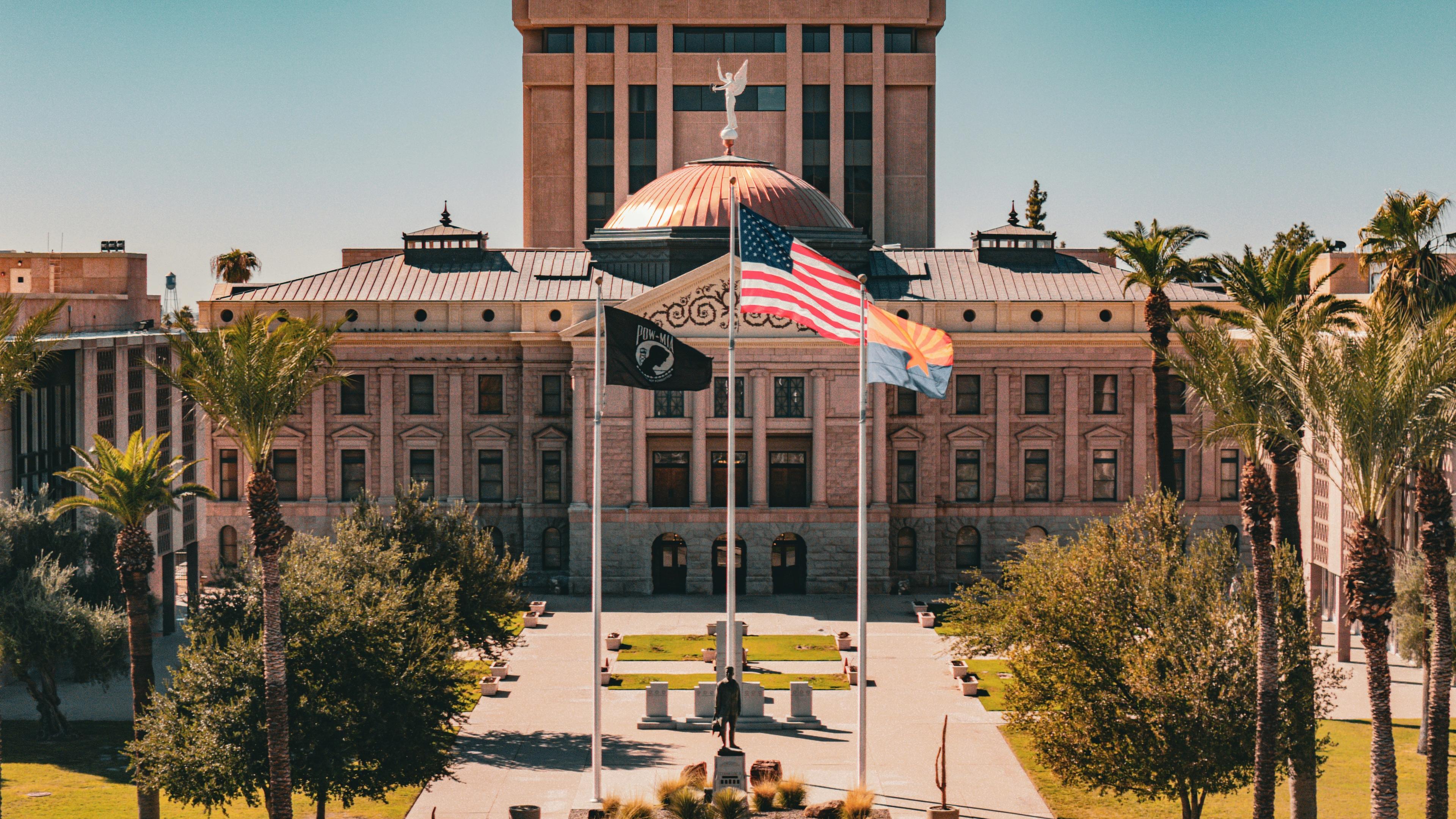 A large building with a flag flying in front of it