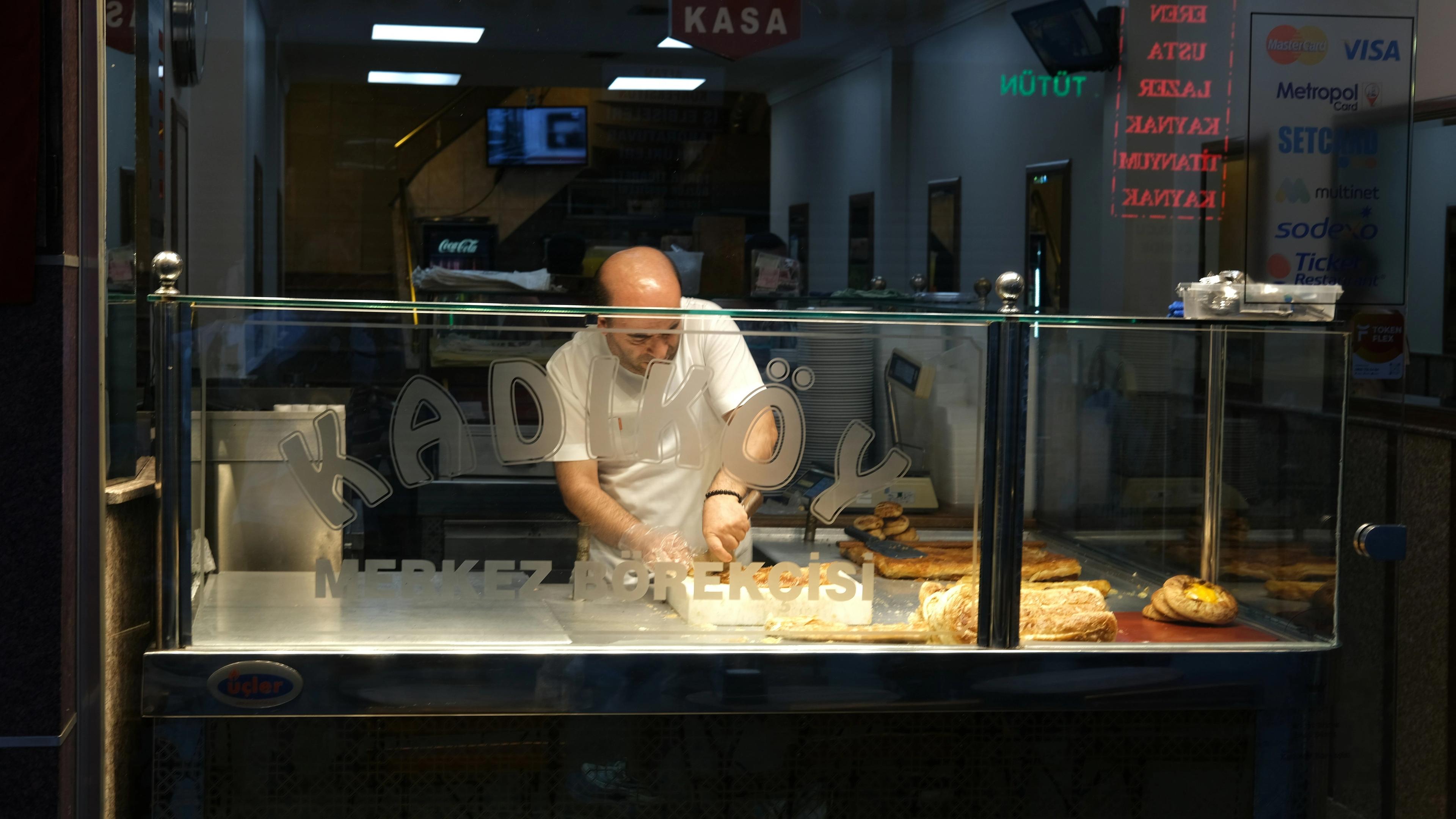 A man standing in front of a counter preparing food