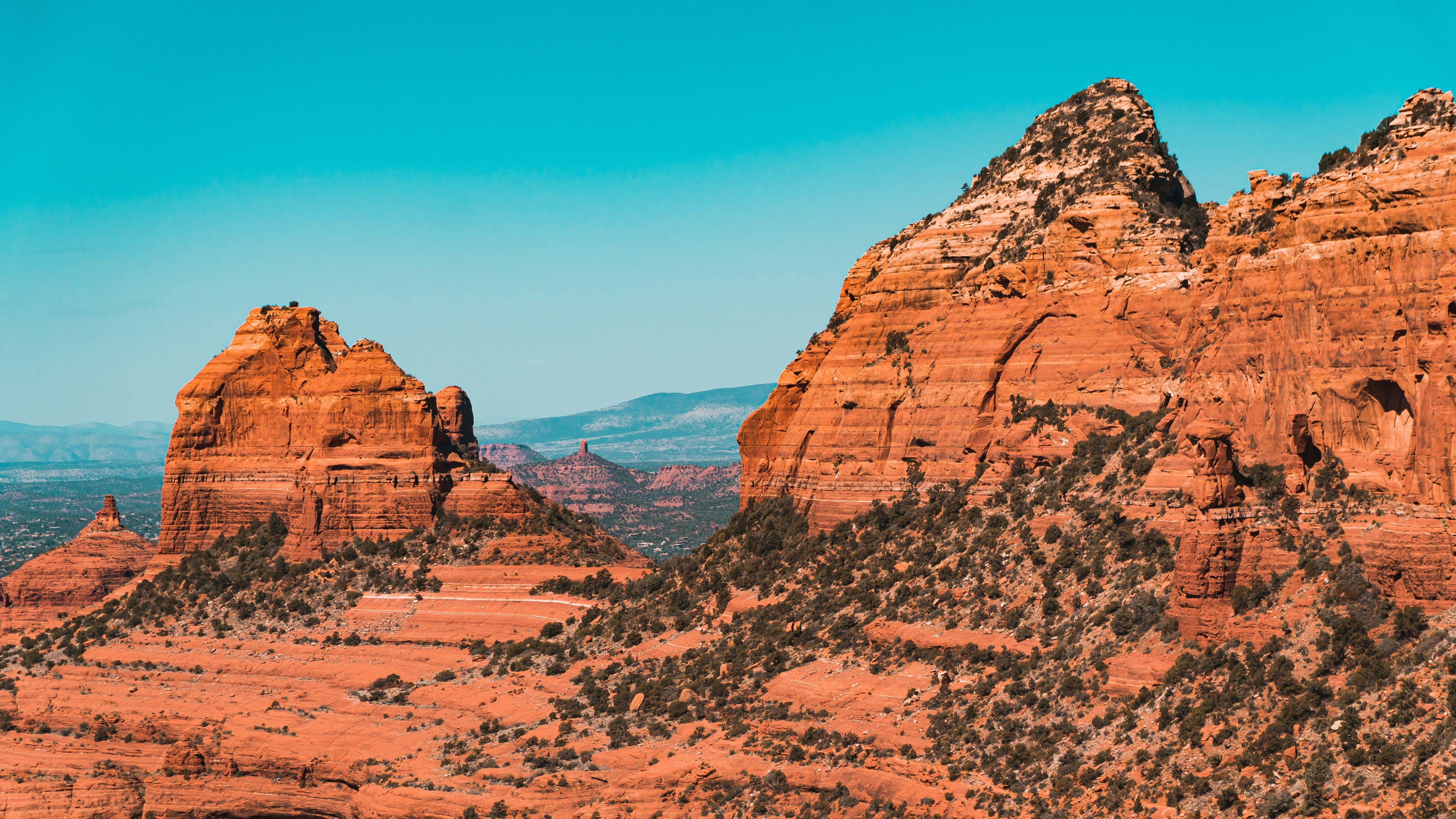Brown rocky mountain under blue sky during daytime