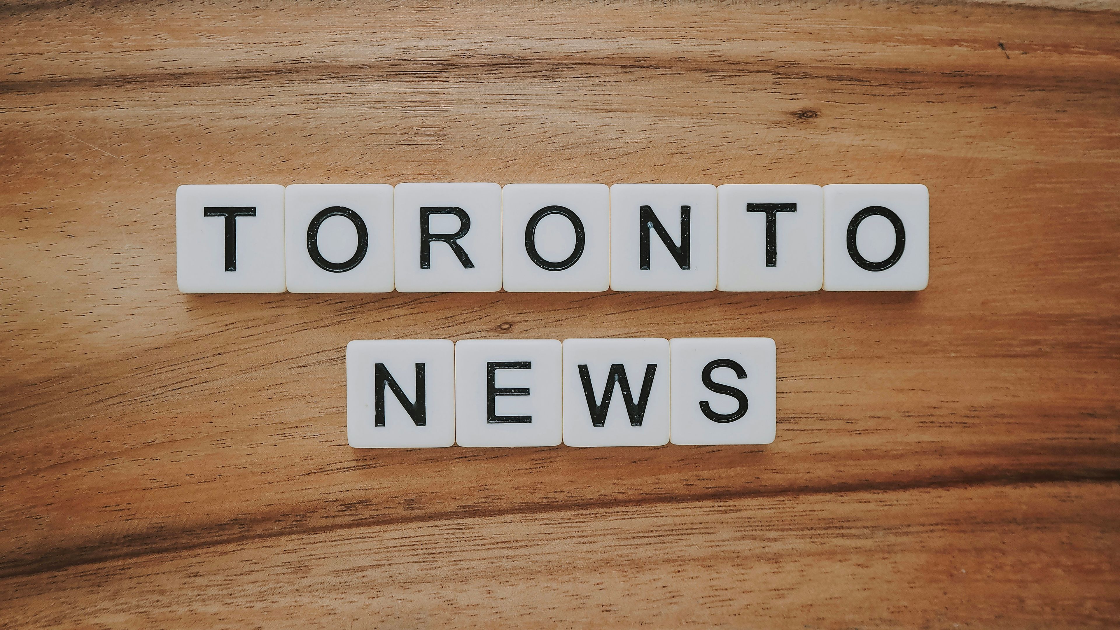 Toronto news artwork on brown wooden surfaec