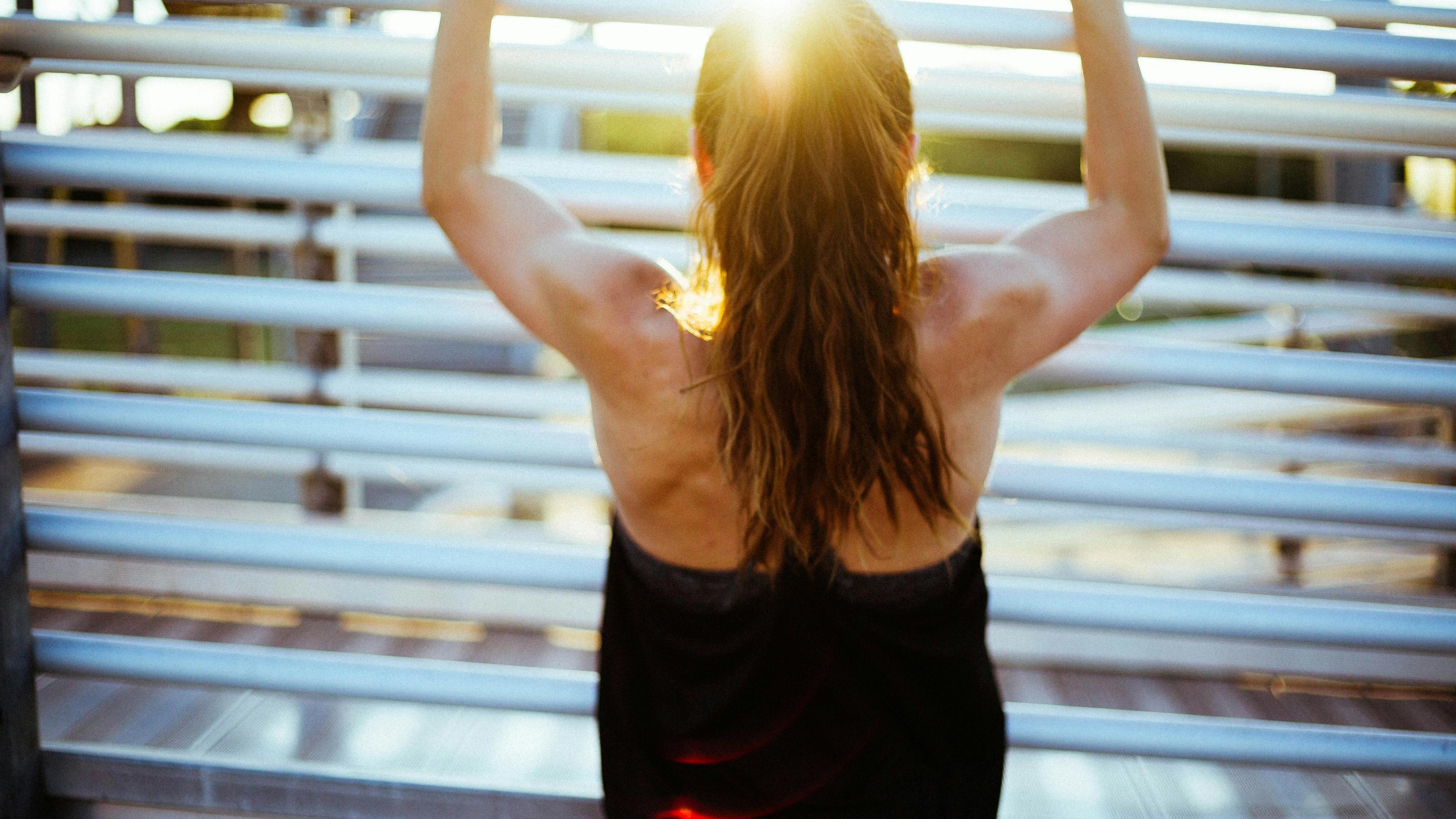 Woman doing pull up exercise