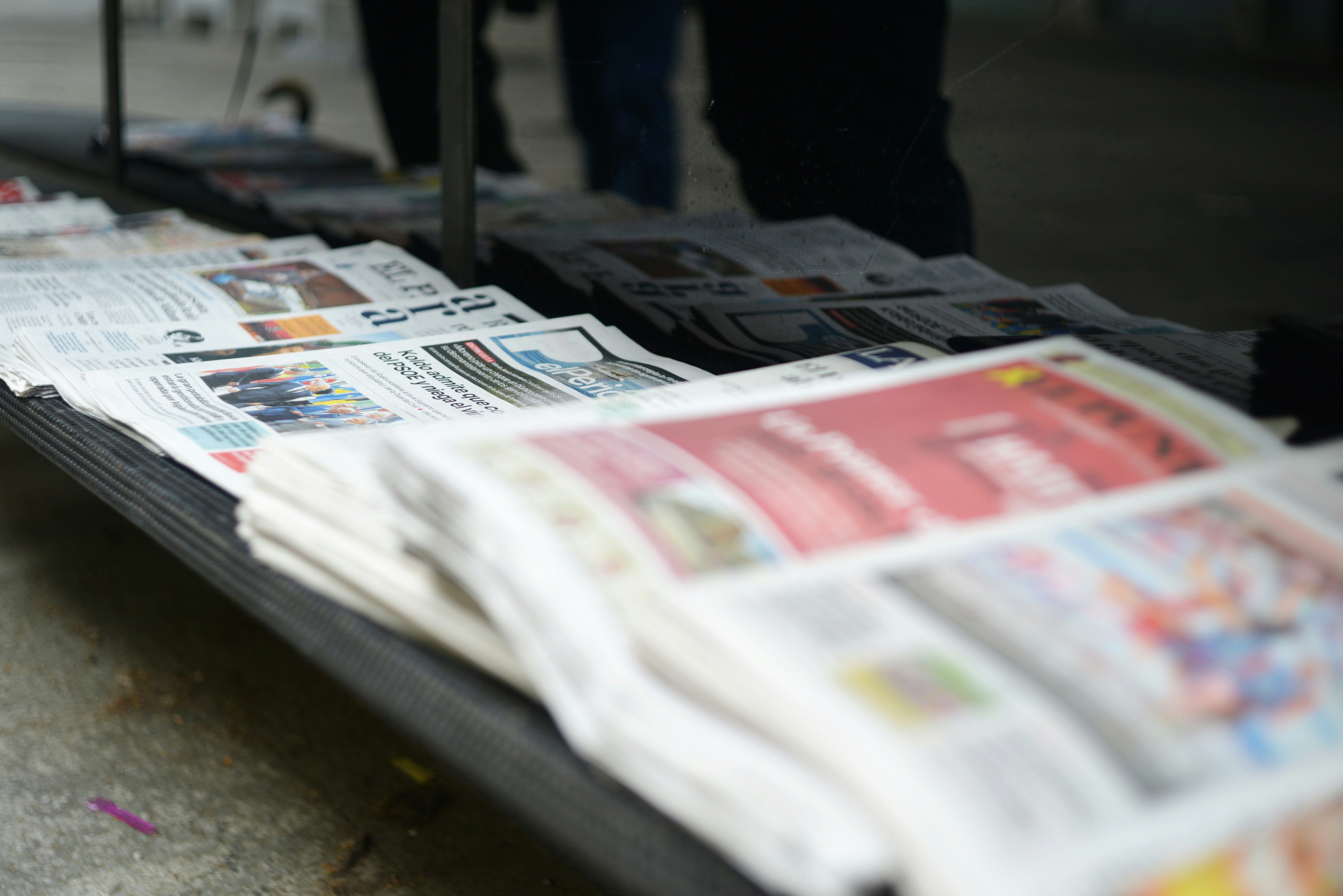 Newspapers neatly stacked on a table