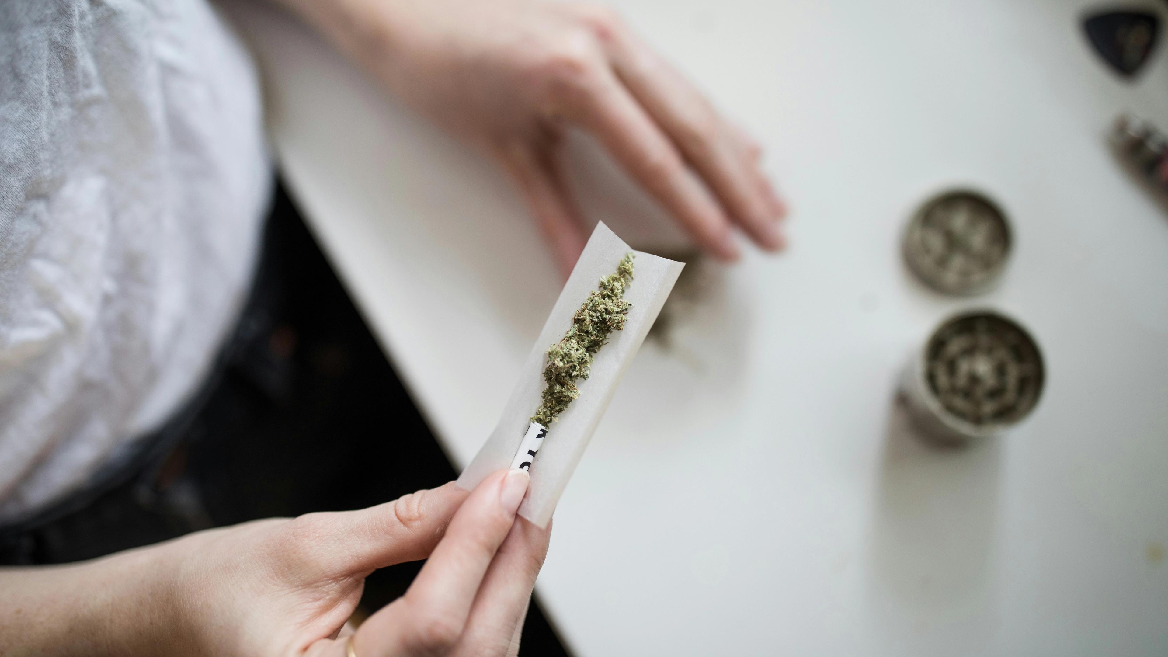 Person making cannabis joint