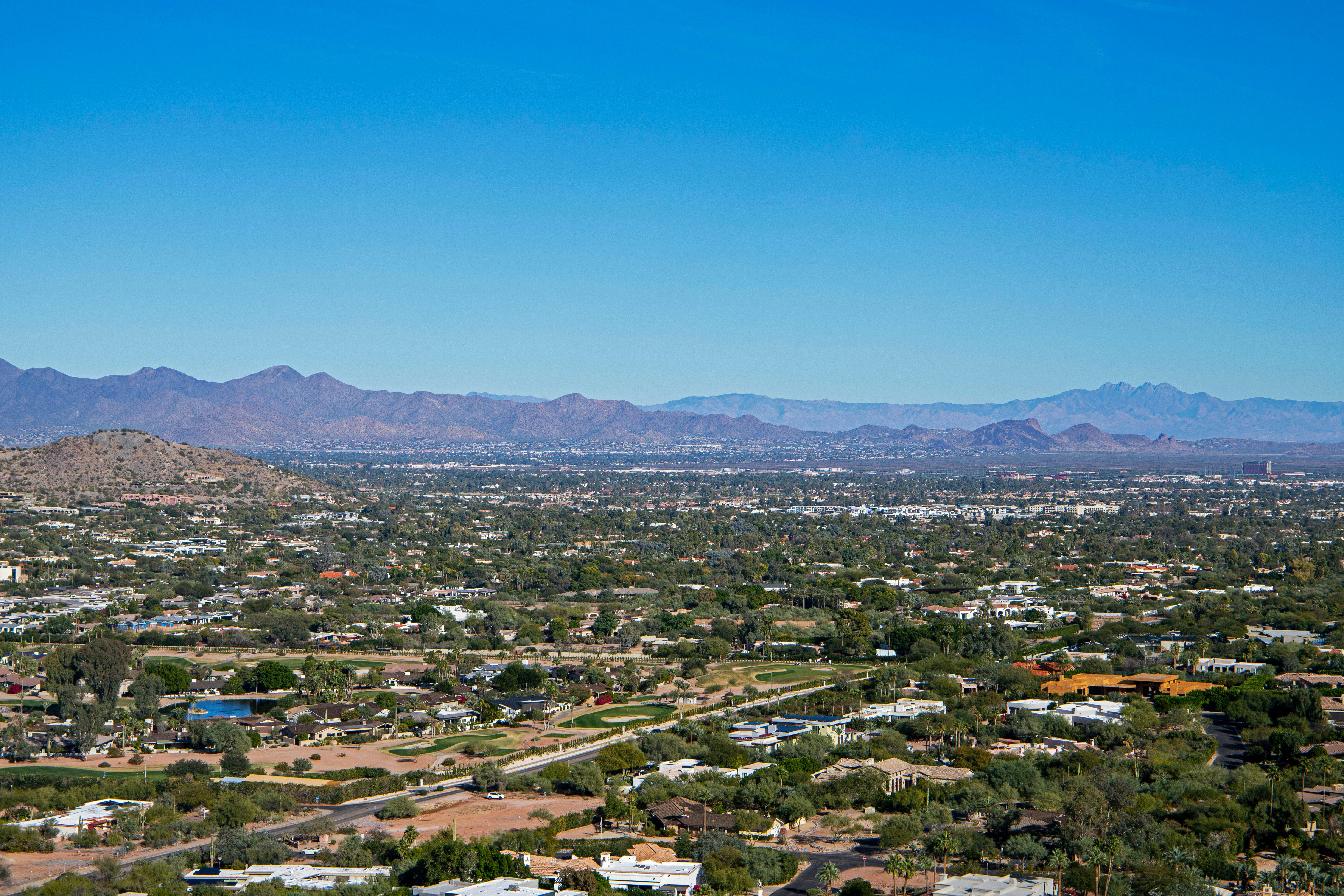 An aerial view of a city with mountains in the background