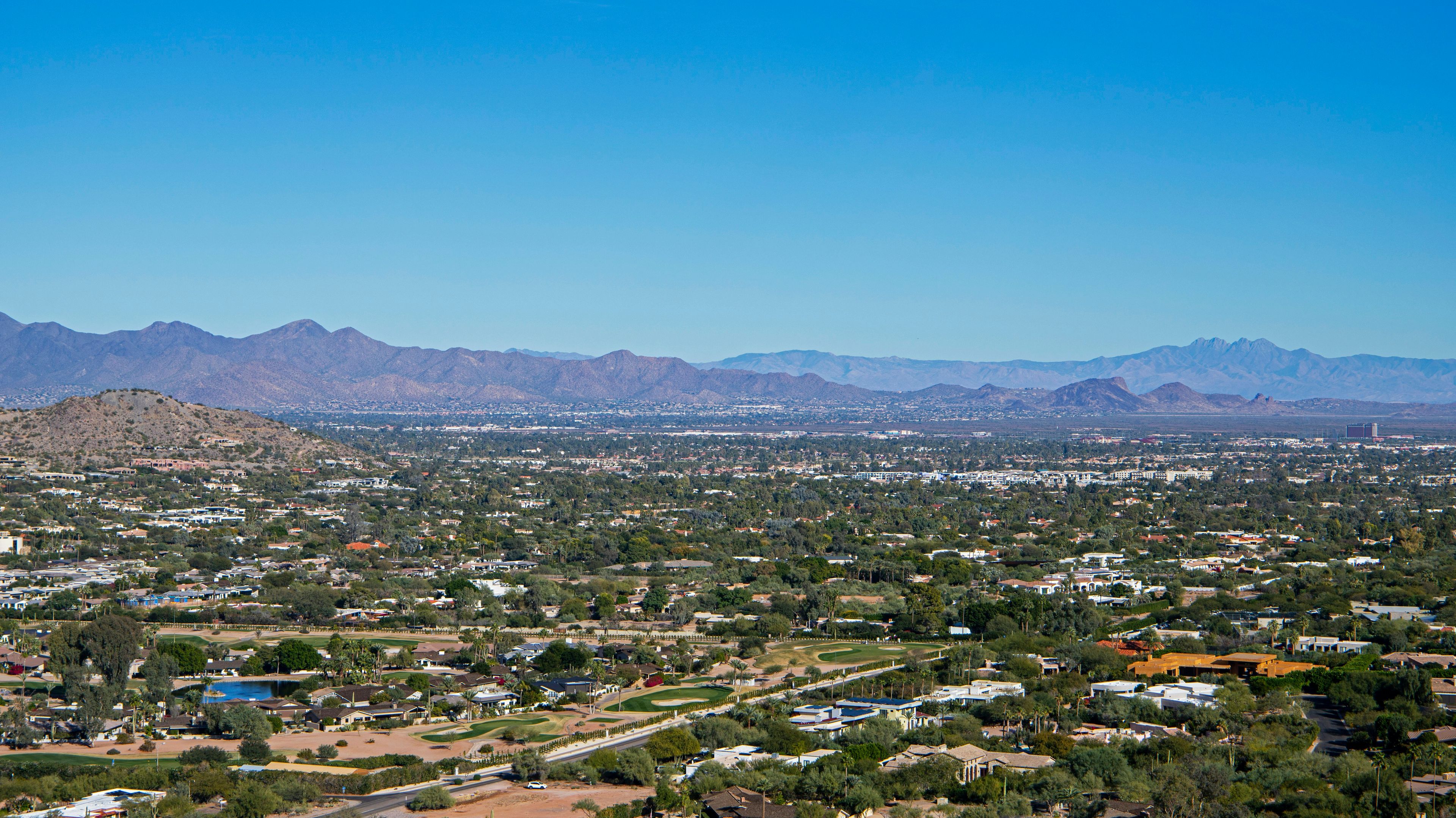 An aerial view of a city with mountains in the background